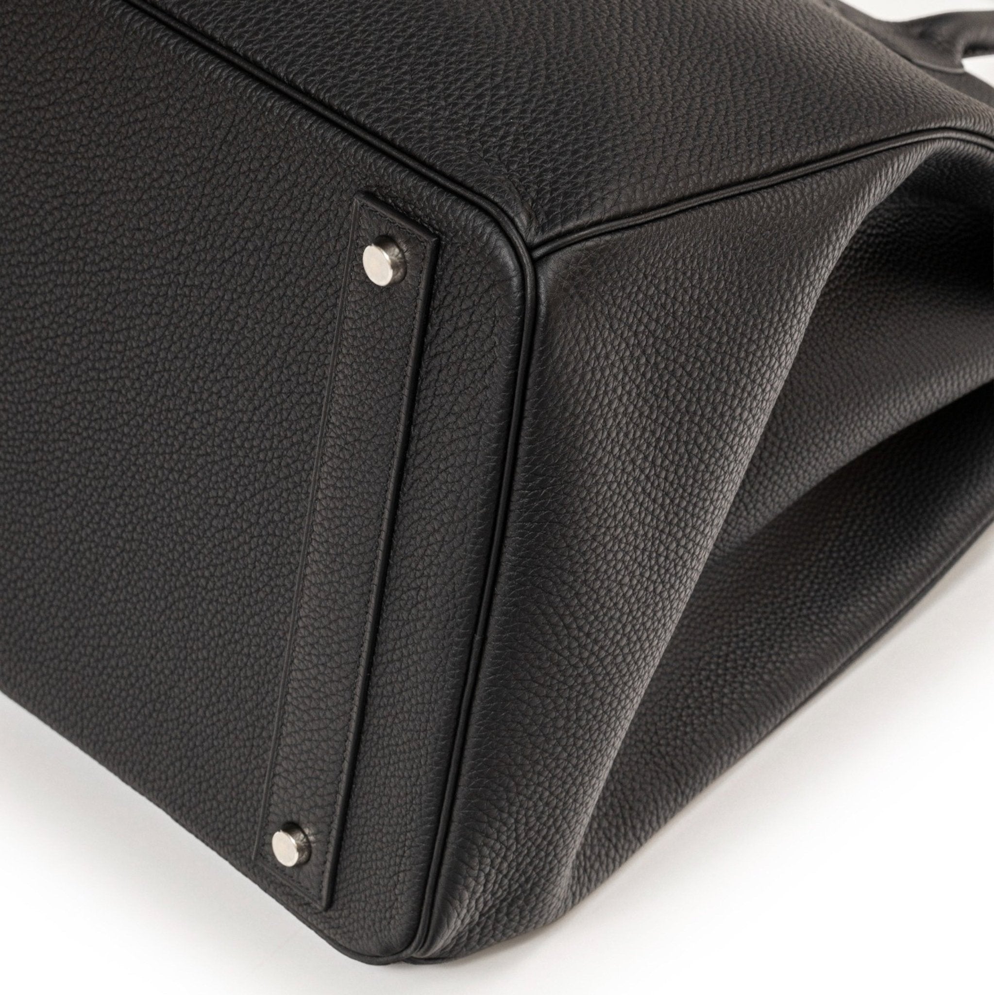 Close-up of the bottom corner of Hermès Hac Birkin 40 Black Togo Palladium Hardware showing leather texture and base feet details.