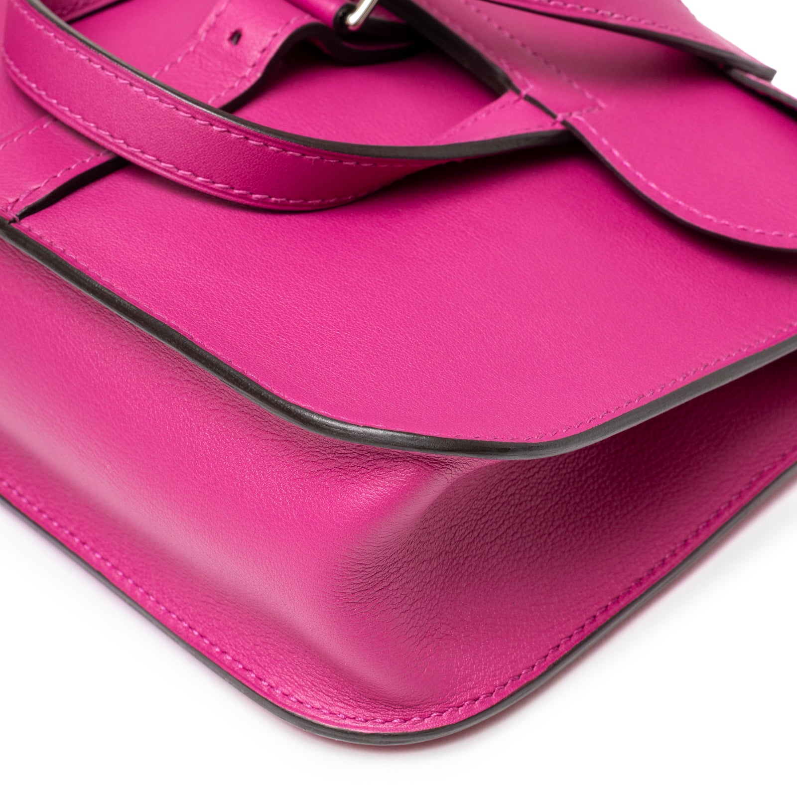 Close-up angled view of Hermès Halzan Mini Rose Pourpre Swift Palladium Hardware showing leather texture and edge detail