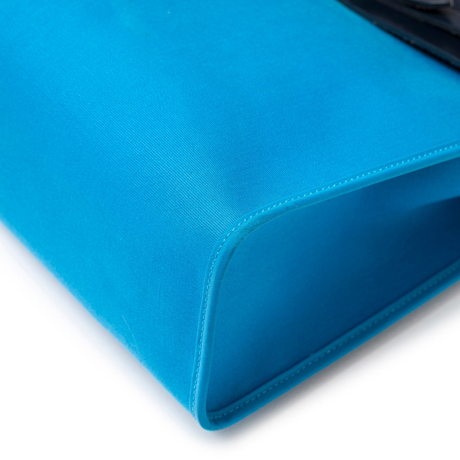 Close-up bottom corner view of Hermès Herbag Zip PM 31 Blue Vache Hunter Palladium Hardware showcasing vibrant blue canvas and stitching detail