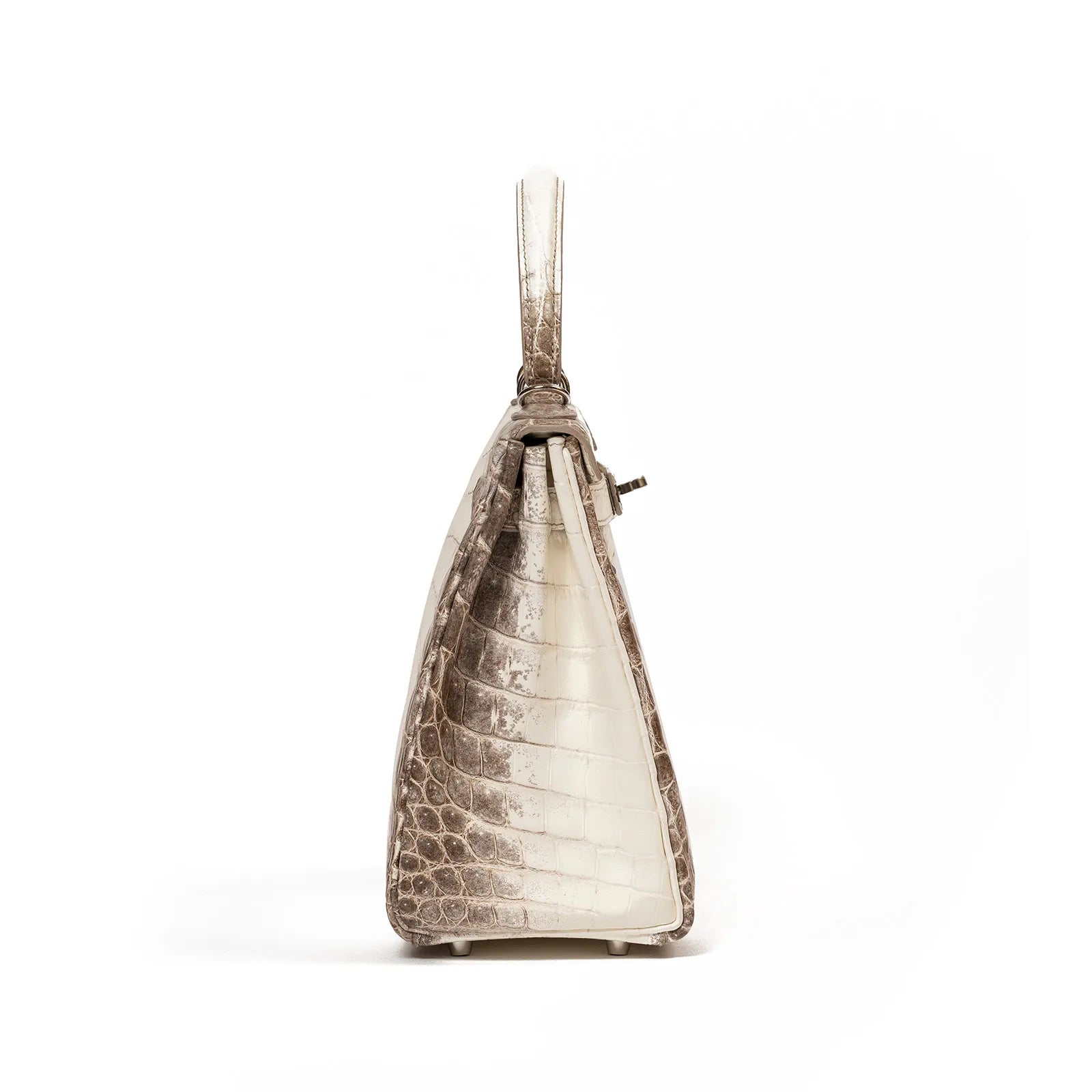 Side view of Hermès Himalaya Kelly 28 Retourne Blanc Matte Niloticus Crocodile Palladium Hardware handbag on white background.