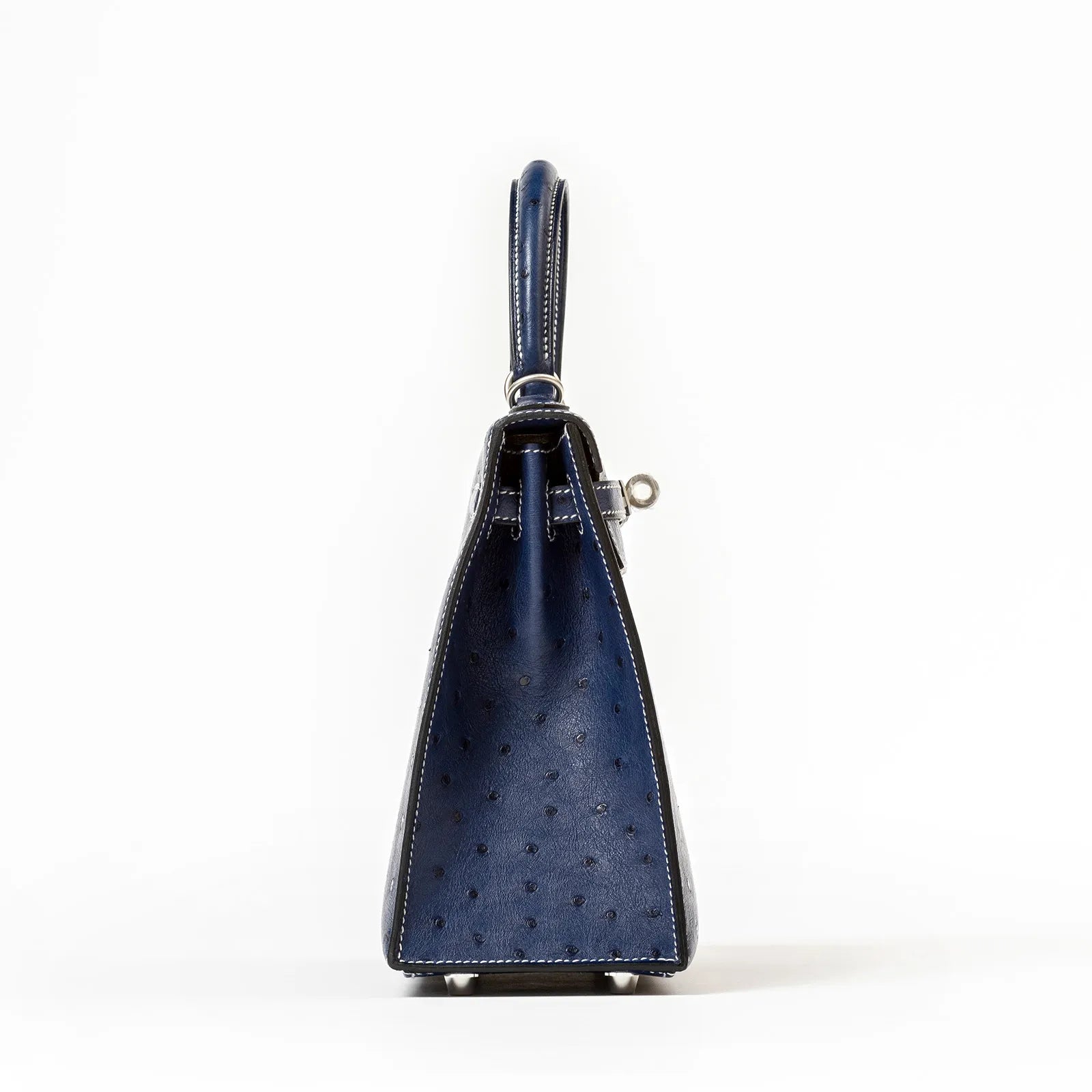 Side view of Hermès Horseshoe Kelly 25 Sellier Ostrich Blue Iris with Gris Brushed Palladium Hardware showing texture and stitching details