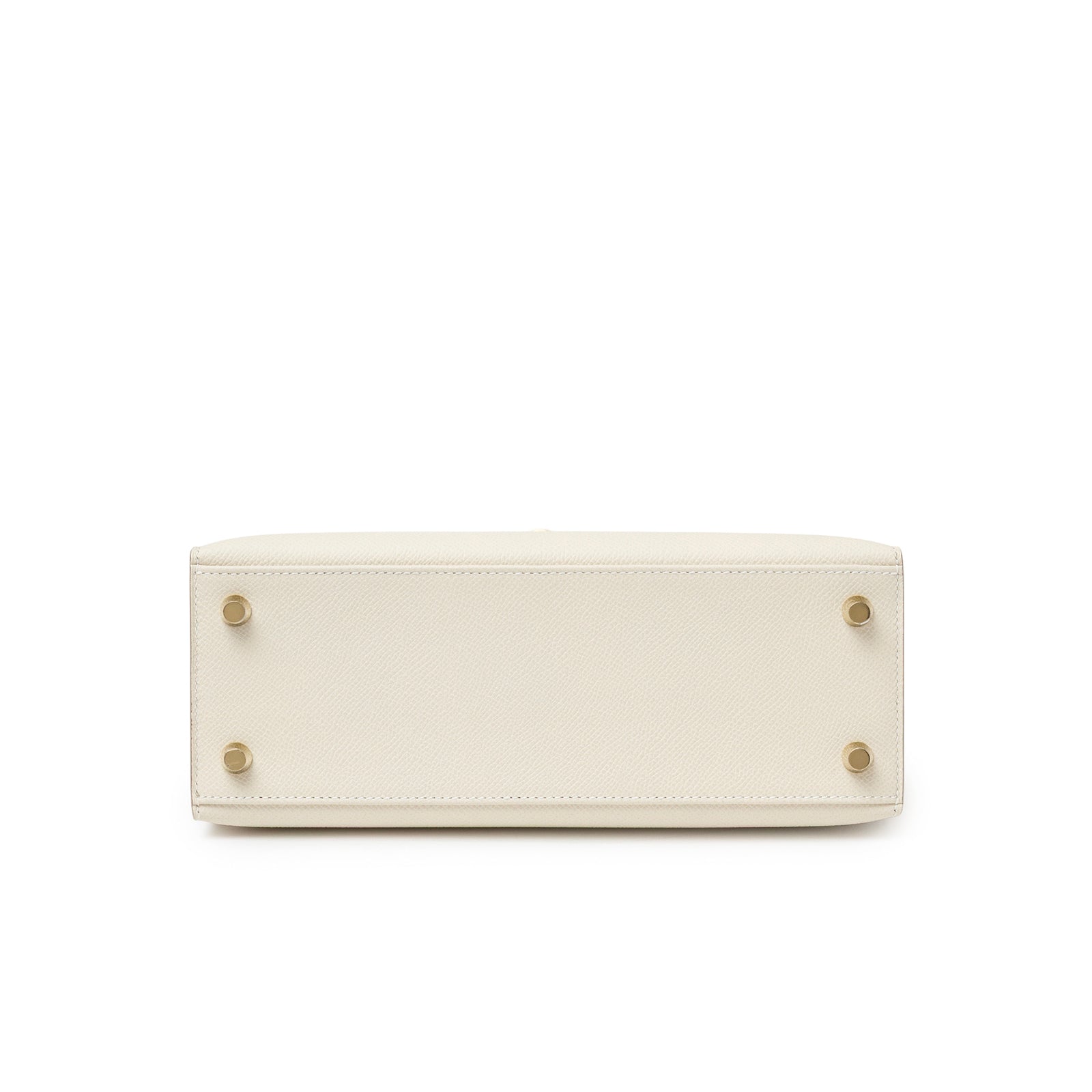 Bottom view of Hermès Kelly 25 Sellier Epsom Craie Permabrass Hardware showing protective feet on white background