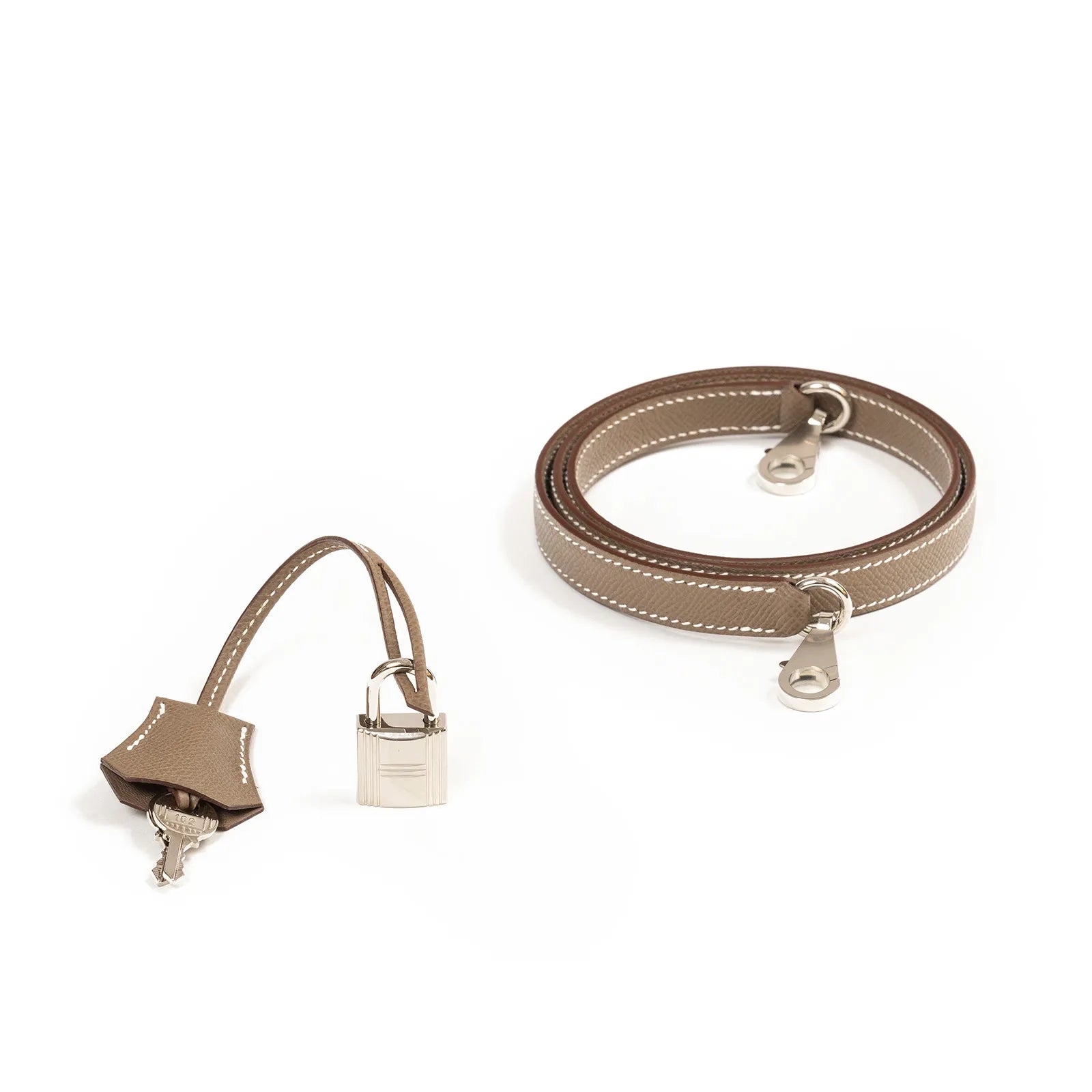 Brown leather strap with silver clasp, leather key holder, and miniature lock on white background.