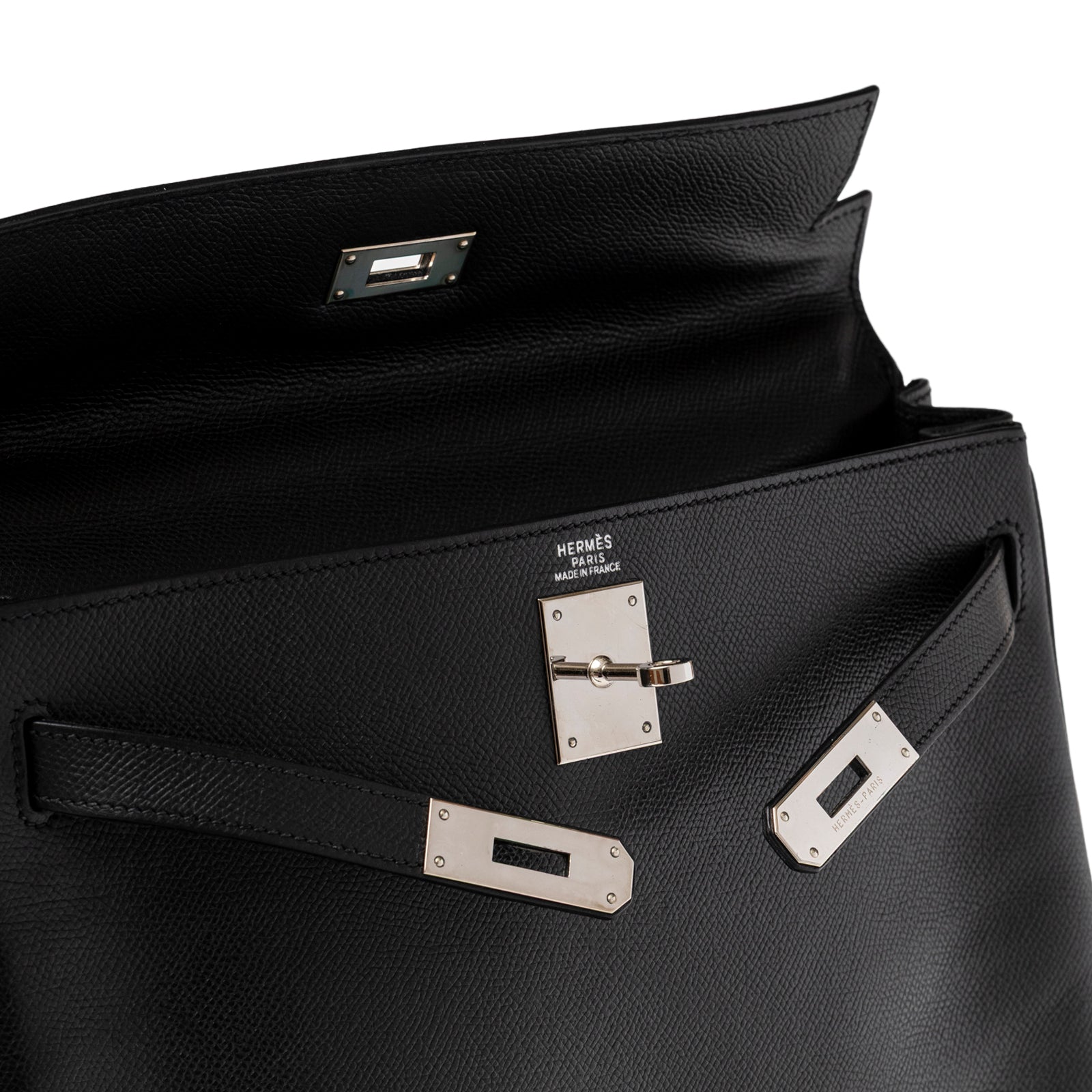 Open flap view of Hermès Kelly 32 Black Epsom Palladium Hardware showing interior and polished clasp detail