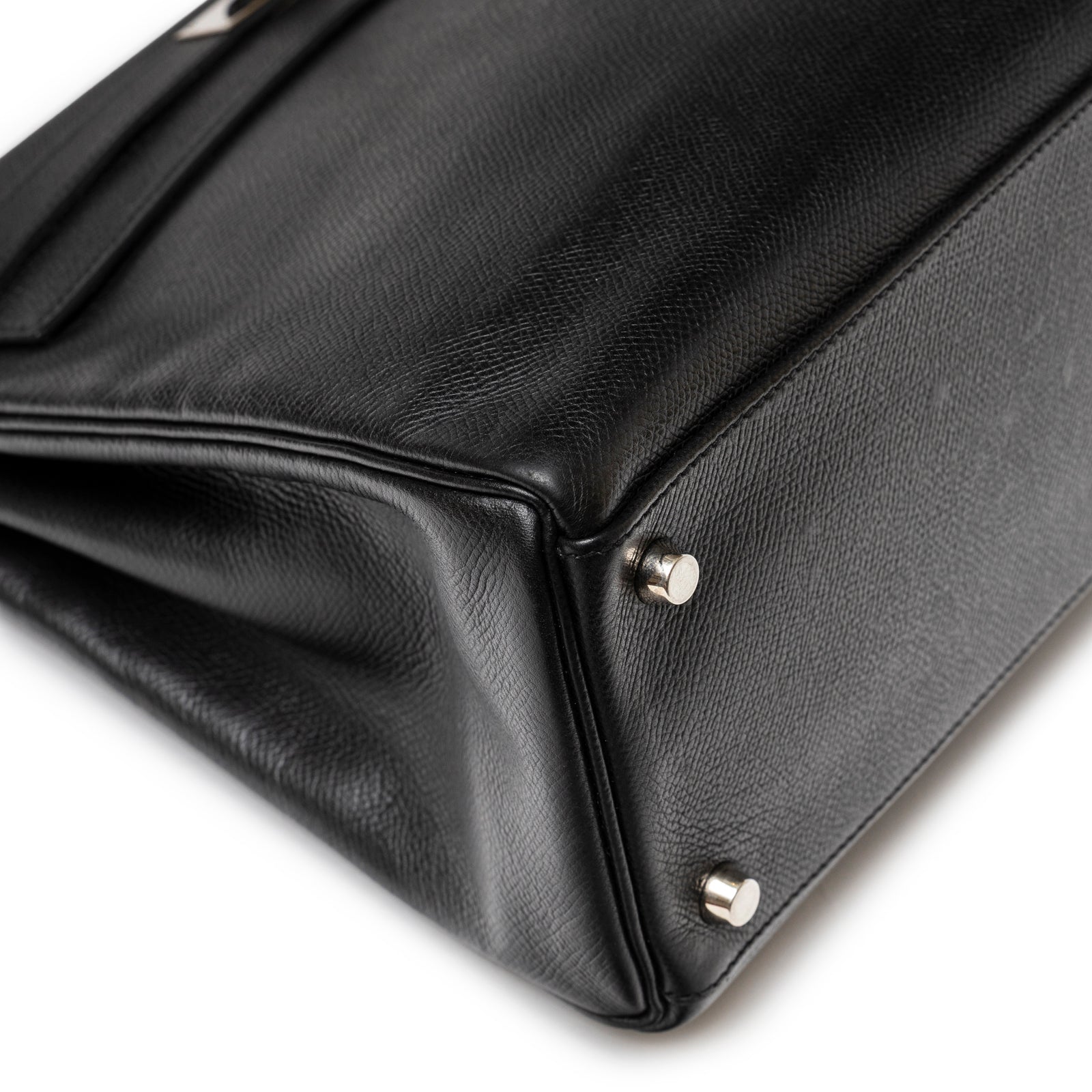 Close-up of Hermès Kelly 32 Black Epsom Palladium Hardware showing textured leather base and metal protective studs