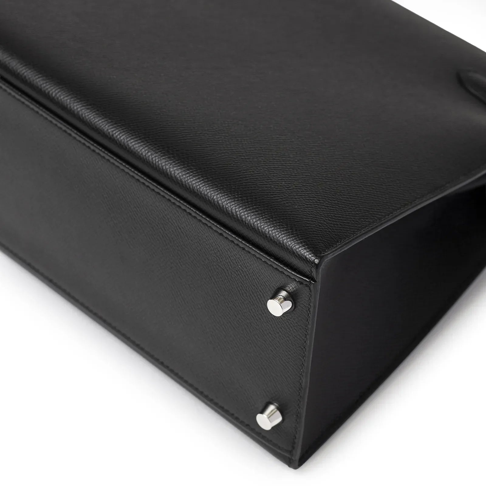 Close-up of bottom corner and palladium feet on Hermès Kelly 32 Sellier Black Epsom Palladium Hardware bag