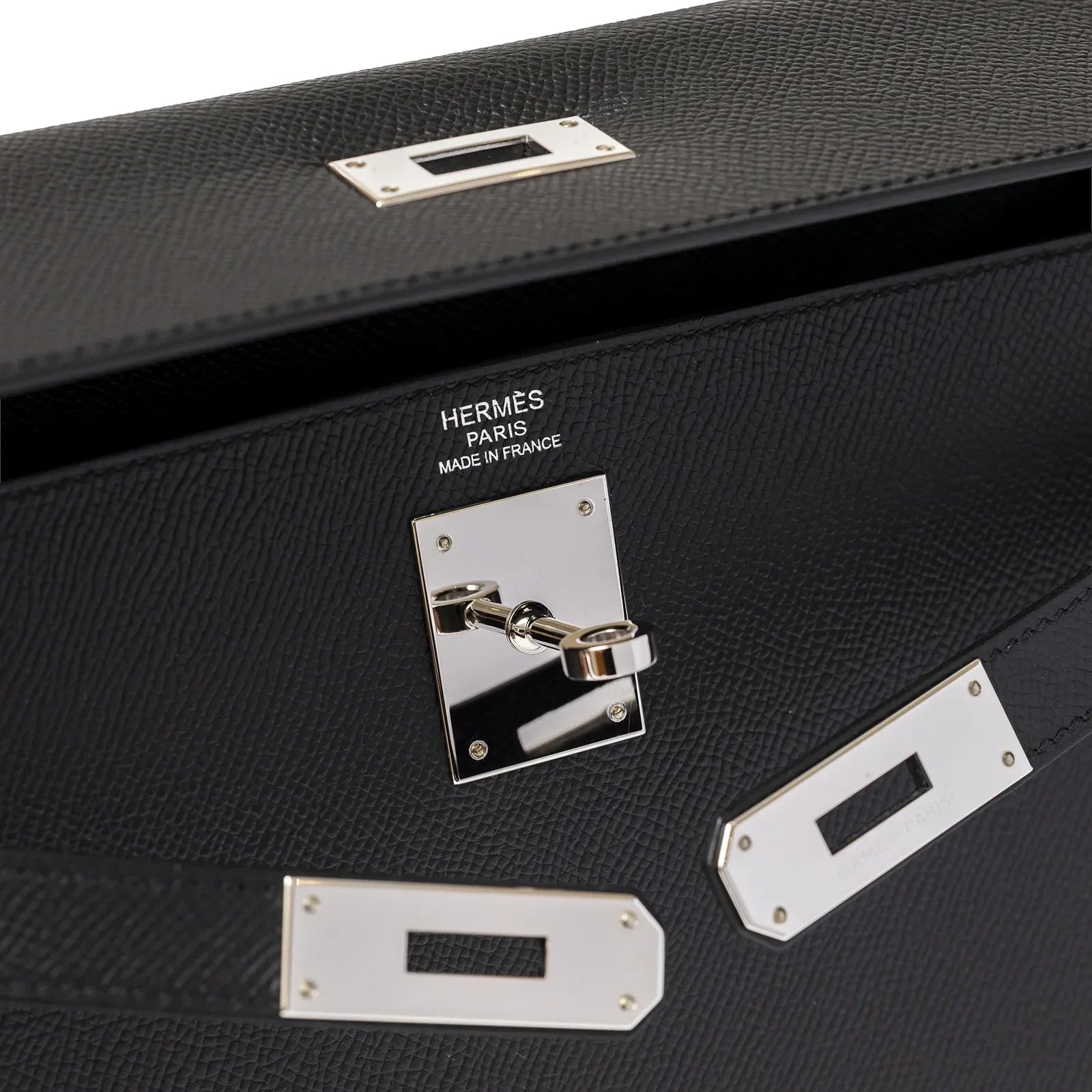 Close-up of Hermès Kelly 32 Sellier Black Epsom Palladium Hardware showing signature lock and brand engraving