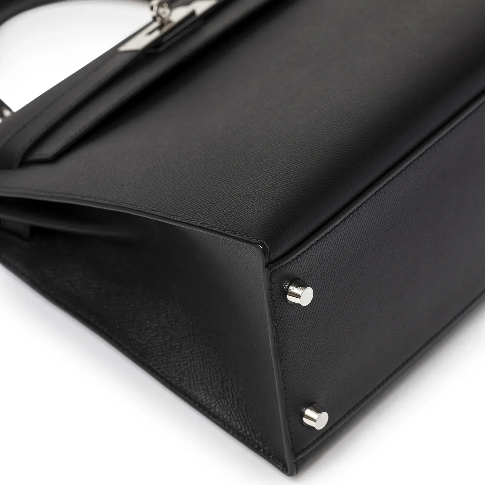 Close-up of base and protective palladium feet on Hermès Kelly 32 Sellier Black Epsom Palladium Hardware handbag