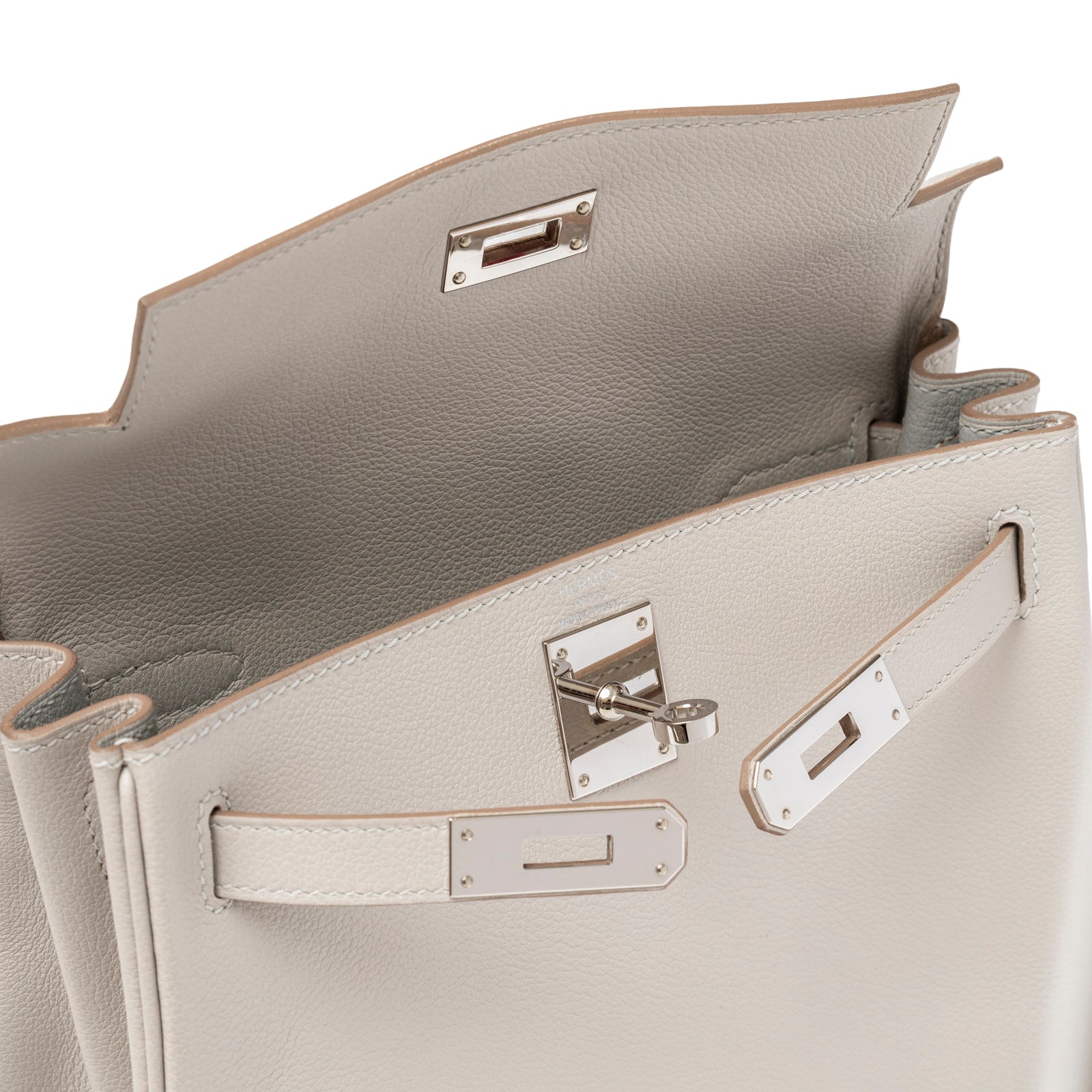 Interior view of Hermès Kelly Ado Backpack Gris Perle Evercolor Palladium Hardware with open flap and fastening detail