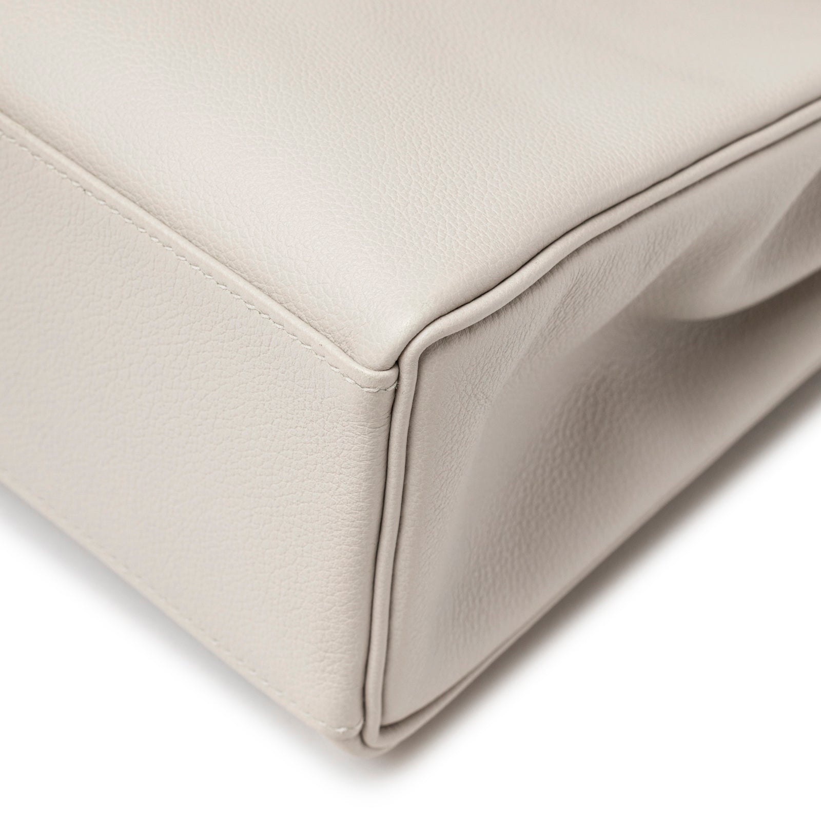 Close-up of corner and seam detail on Hermès Kelly Ado Backpack Gris Perle Evercolor Palladium Hardware showing textured leather craftsmanship