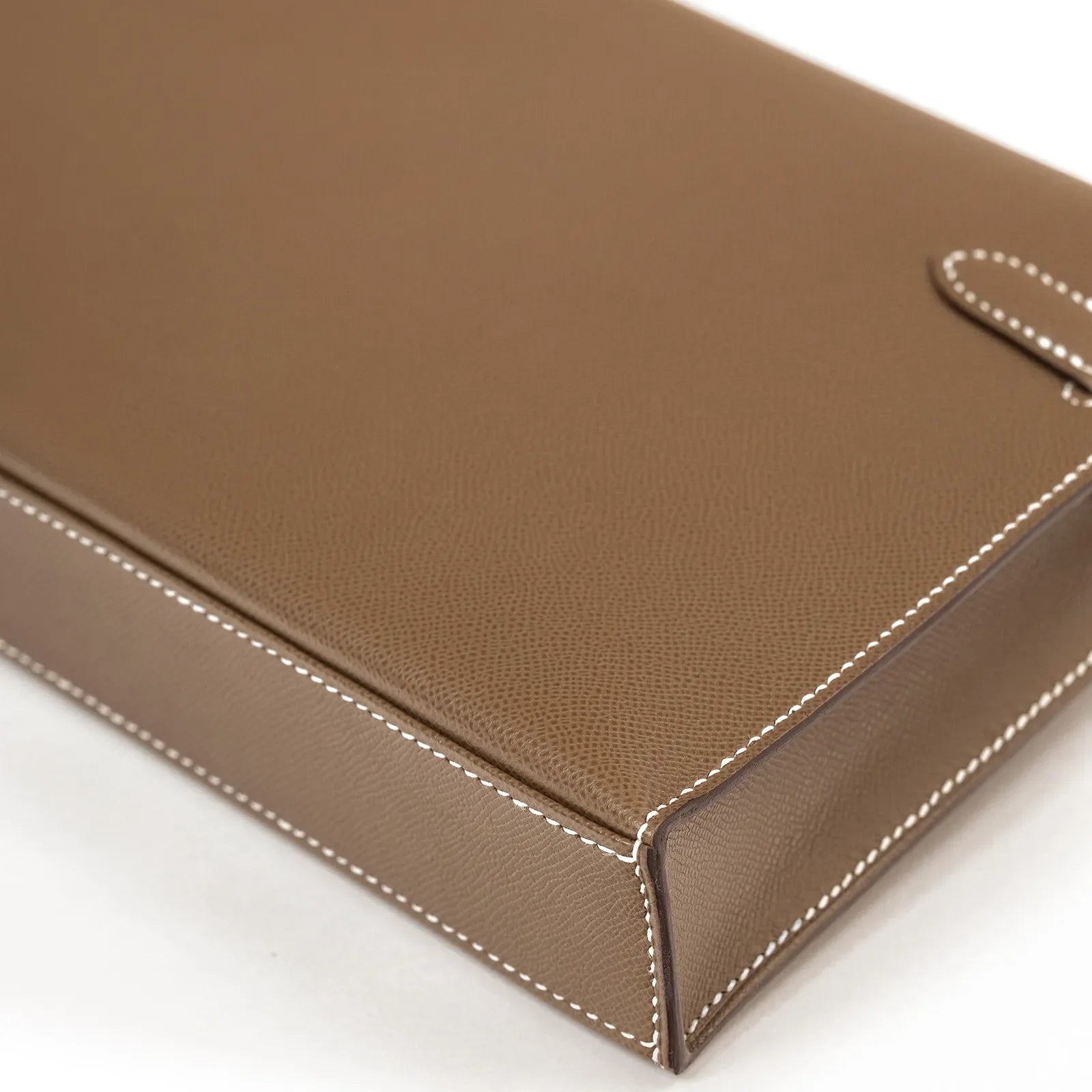 Close-up angled view of Hermès Kelly Elan Etoupe Madame Palladium Hardware showing leather texture and white stitching detail