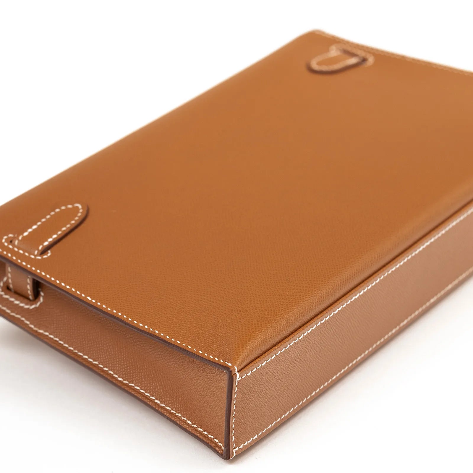 Angled close-up of Hermès Kelly Elan Gold Madame Gold Hardware showing smooth leather and white stitching details