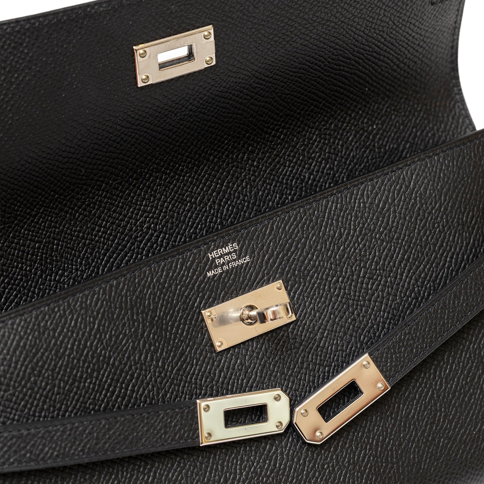 Close-up of Hermès Kelly Long Wallet Black Epsom Palladium Hardware showing clasp and logo detail inside flap