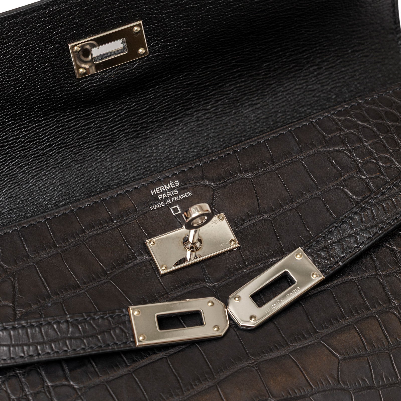 Close-up of Hermès Kelly Long Wallet Black Matte Alligator Palladium Hardware clasp and texture detail