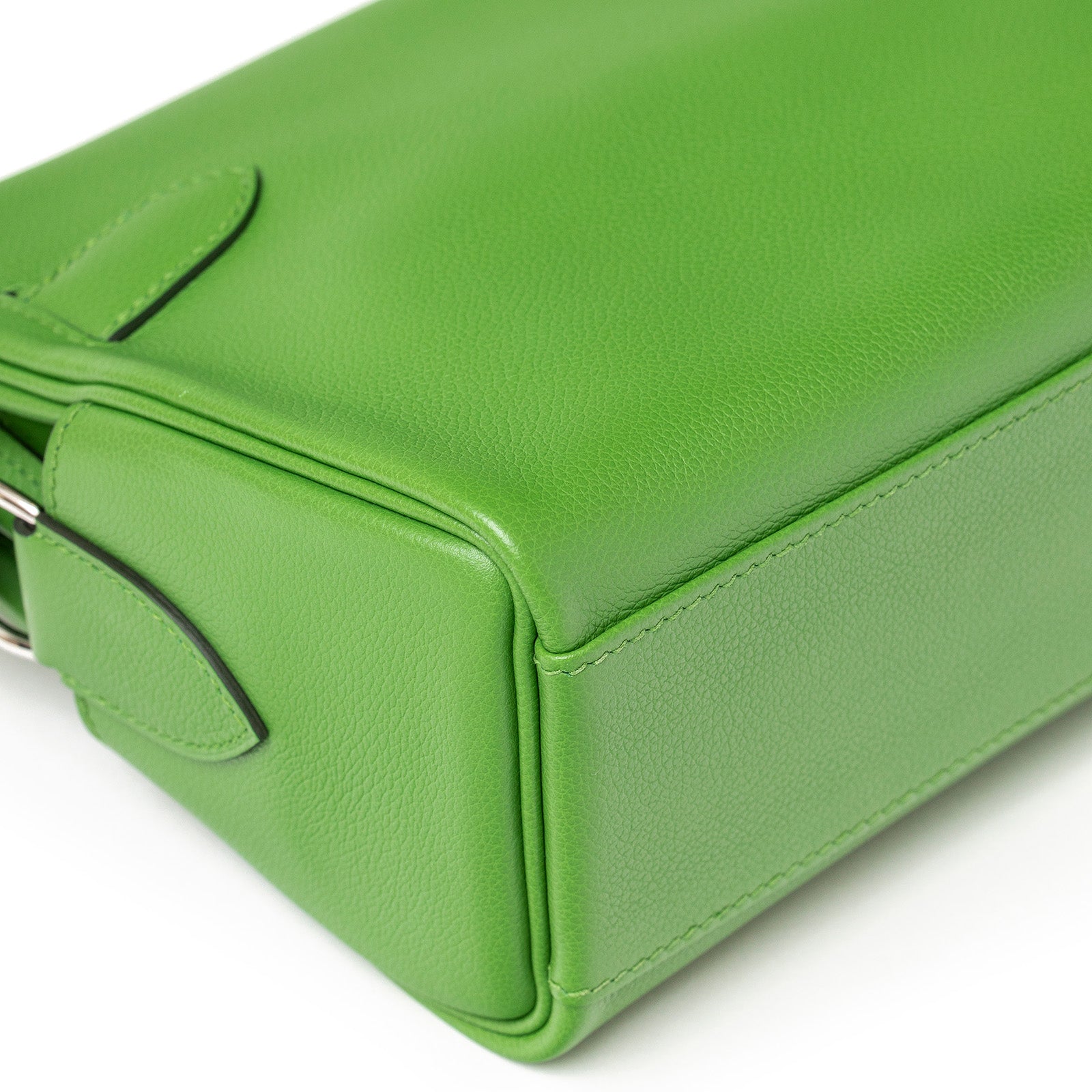 Side view of Hermès Kelly Messenger PM Vert Yucca Evercolor Palladium Hardware bag with smooth texture and visible stitching details.