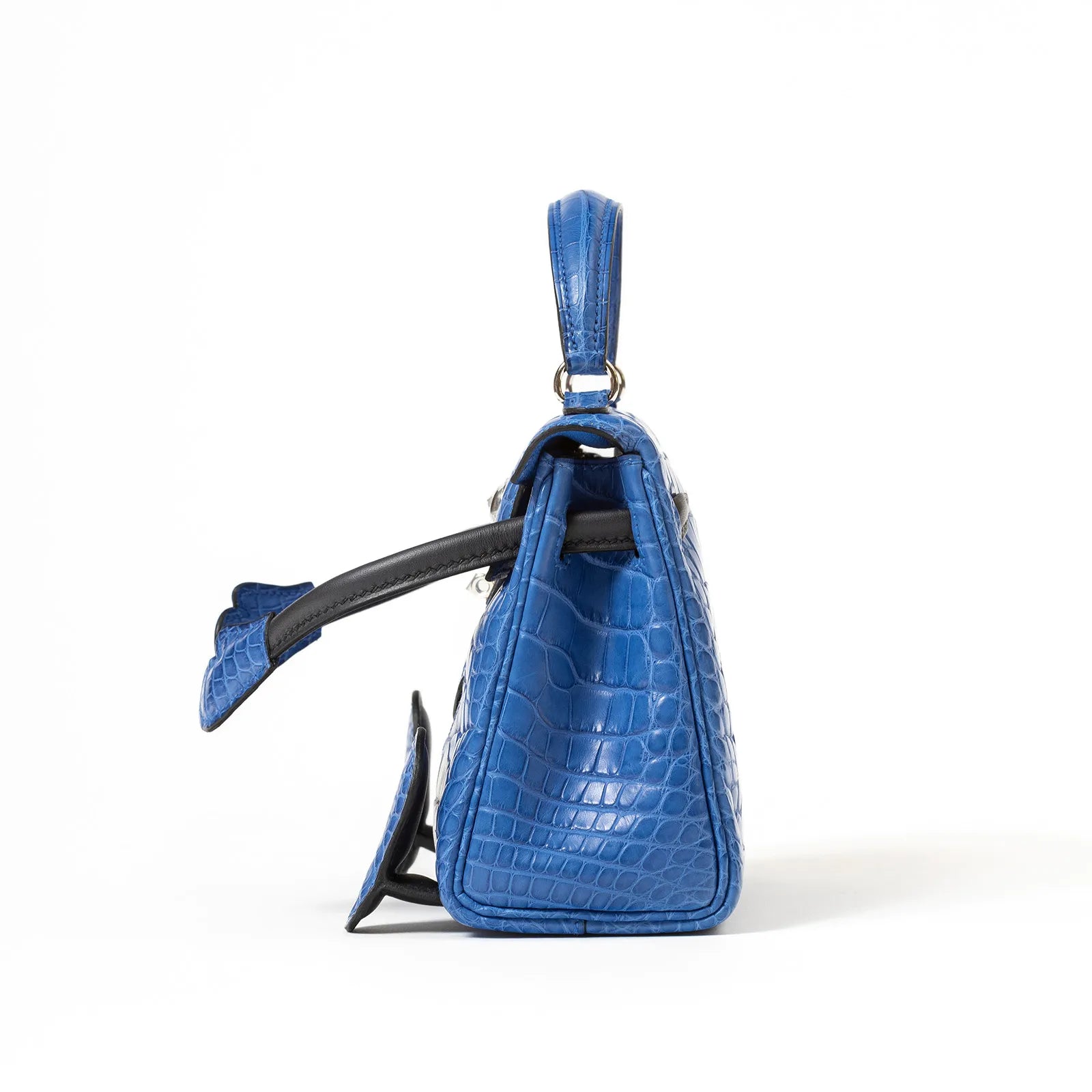 Side view of Hermès Kelly Quelle Idole Doll Bag AB Bleu Zellige/Bleu Indigo Palladium Hardware showing crocodile texture