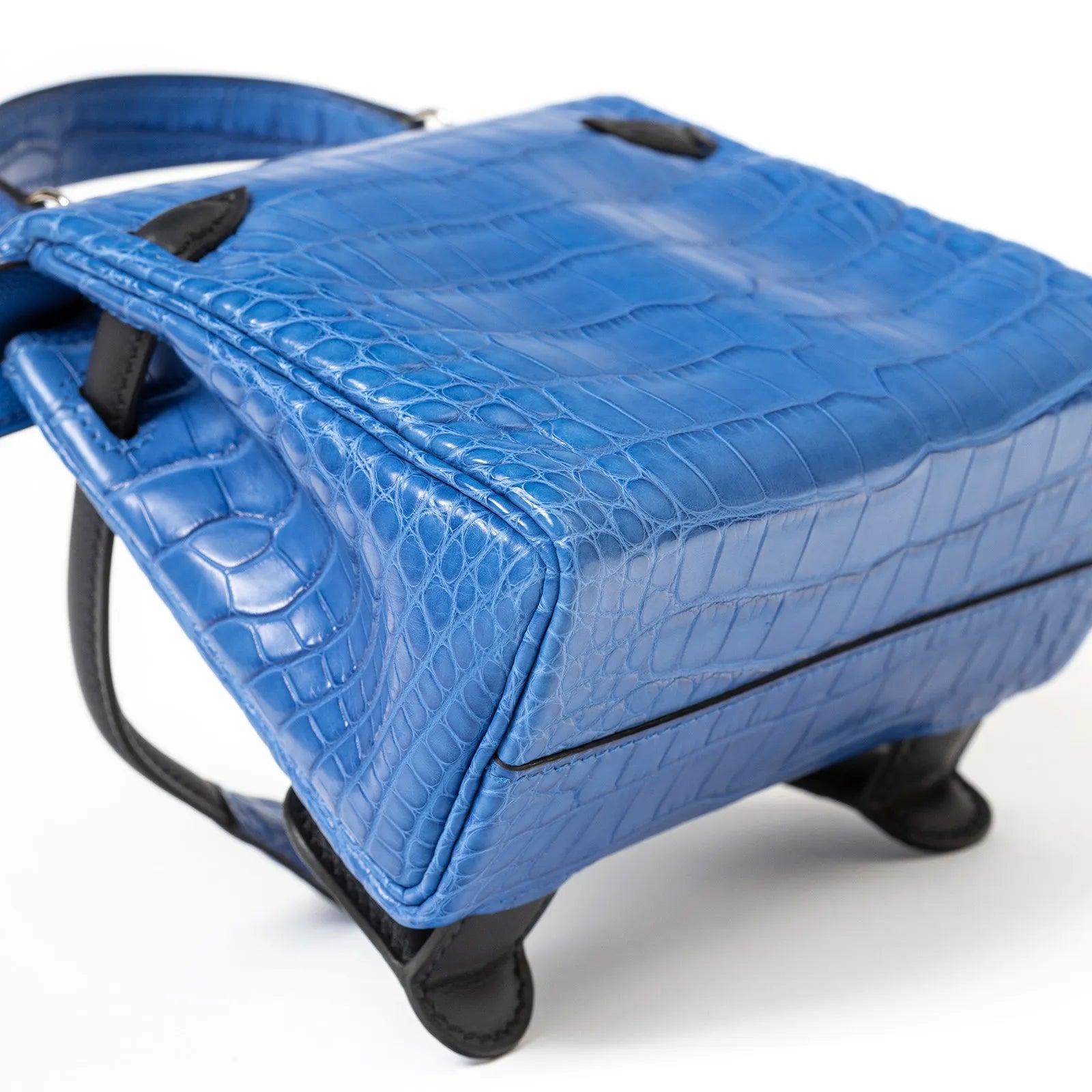 Close-up of bottom and side view of Hermès Kelly Quelle Idole Doll Bag AB Bleu Zellige/Bleu Indigo Palladium Hardware showing texture and stitching