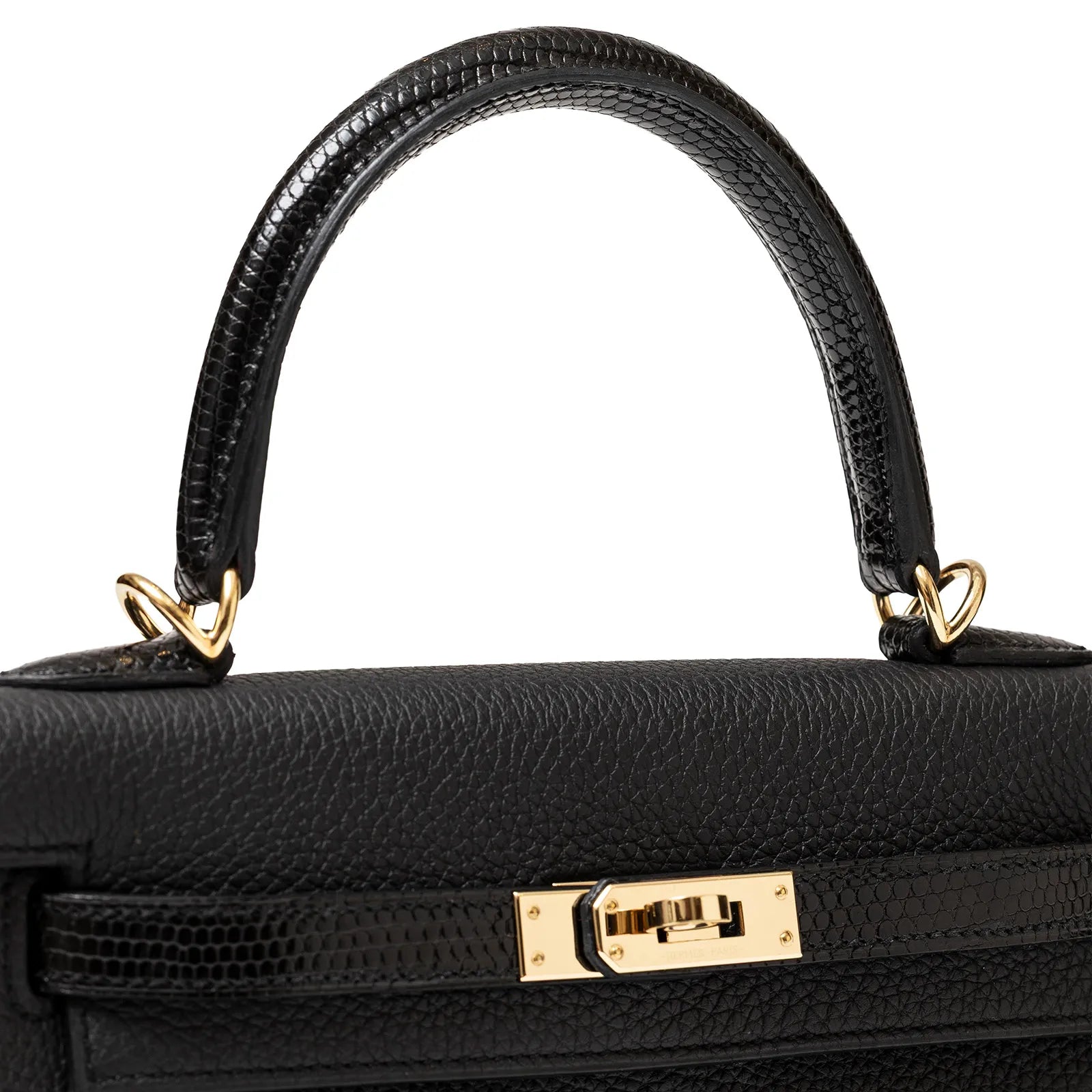 Top view of Hermès Kelly 25 Retourne Black Touch Togo/Lizard Permabrass Hardware handbag with gold hardware and textured finish.