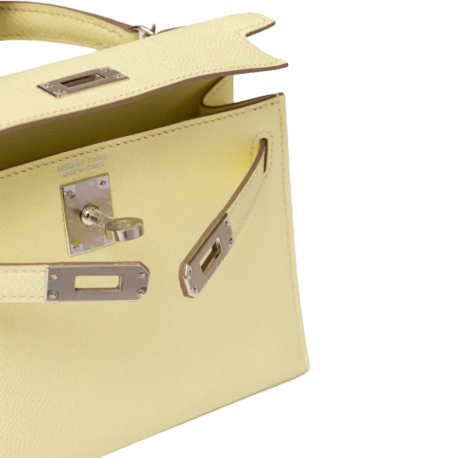 Close-up of open Hermès Mini Kelly II Sellier 20 Jaune Milton Epsom Palladium Hardware showing interior and clasp details