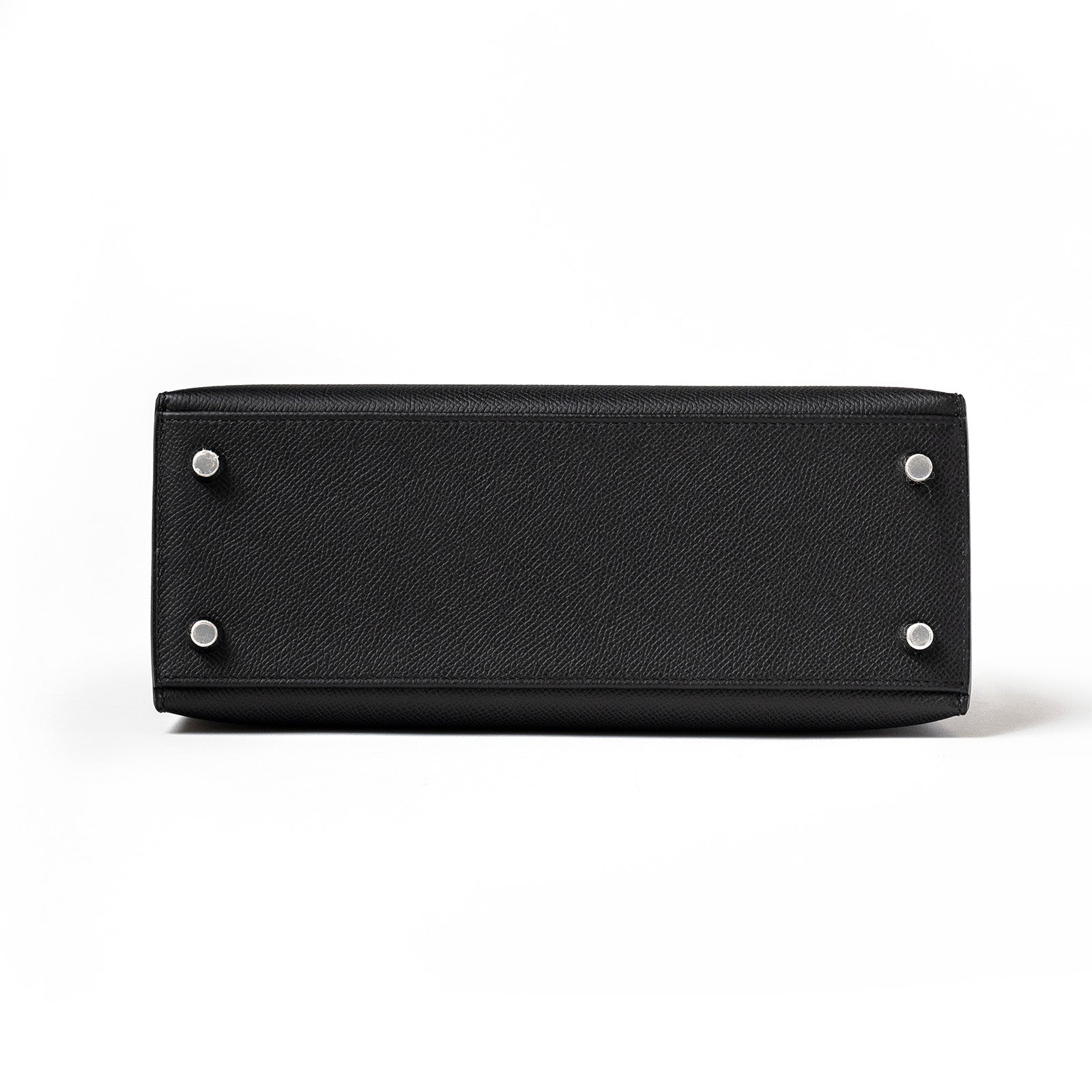 Bottom view of Hermès Kelly 25 Sellier Black Epsom Palladium Hardware showing protective metal feet and textured leather surface