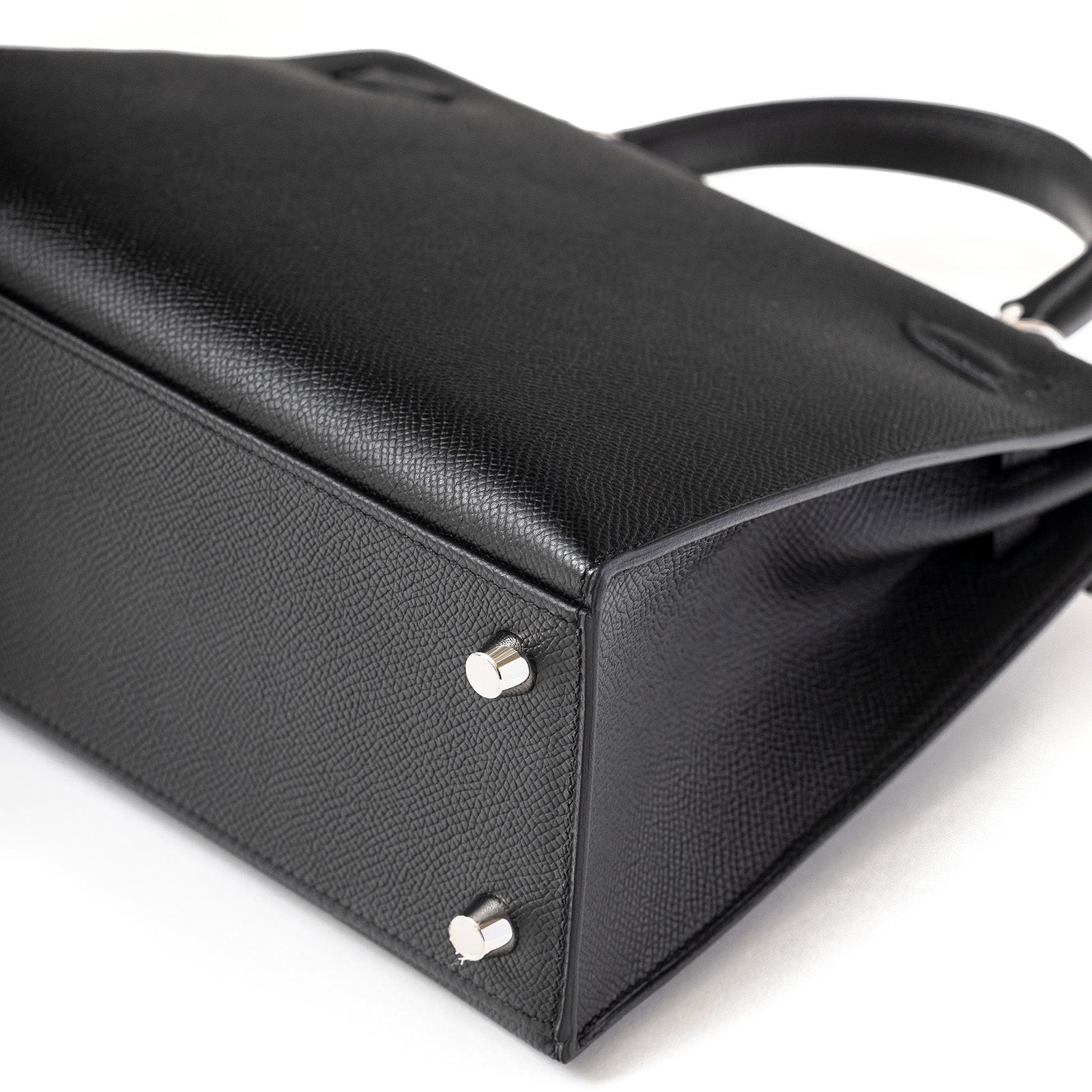 Close-up of bottom corner showing texture and palladium hardware on Hermès Kelly 25 Sellier Black Epsom Palladium Hardware