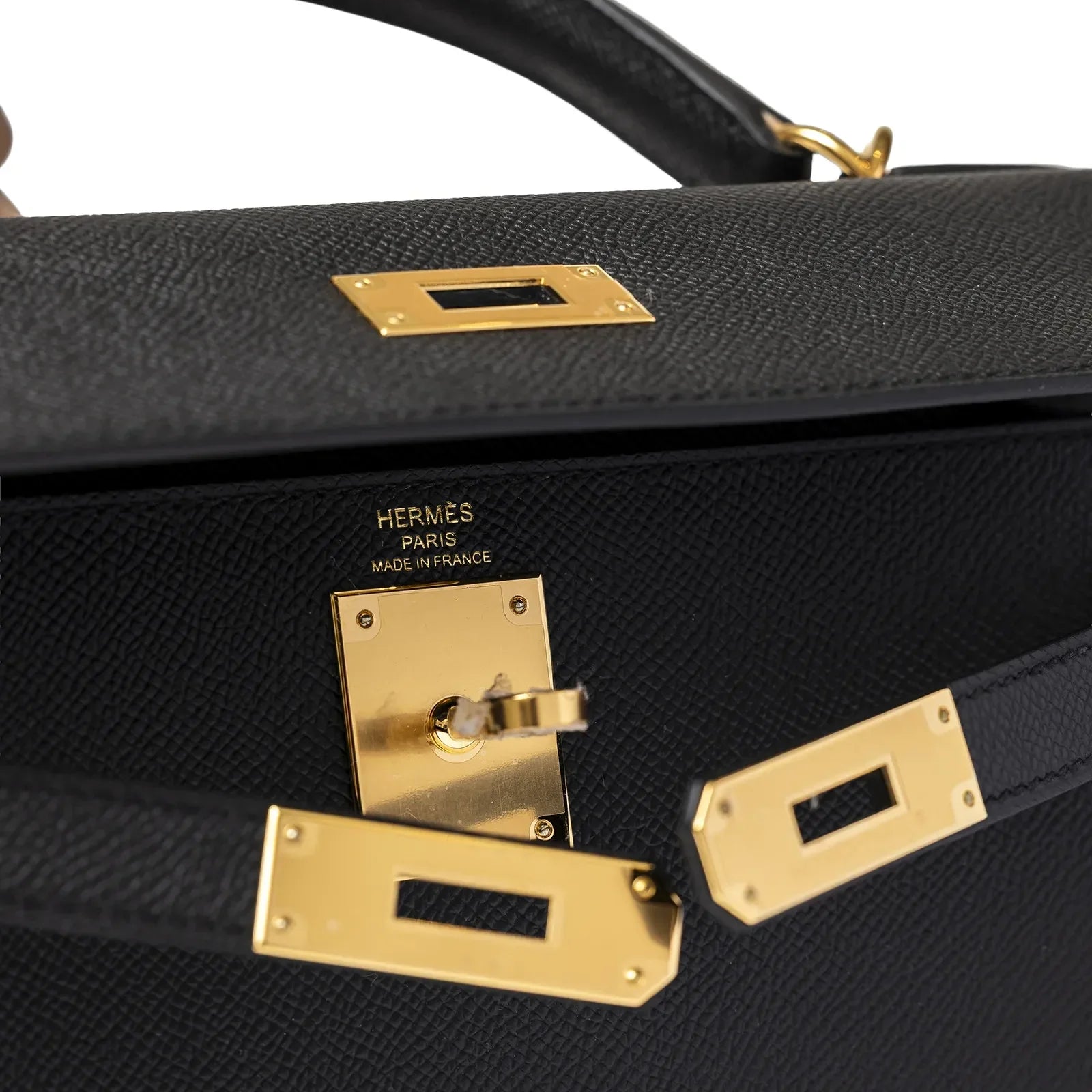 Close-up of Hermès Kelly 28 Sellier Black Epsom Gold Hardware showing lock and strap details on black leather