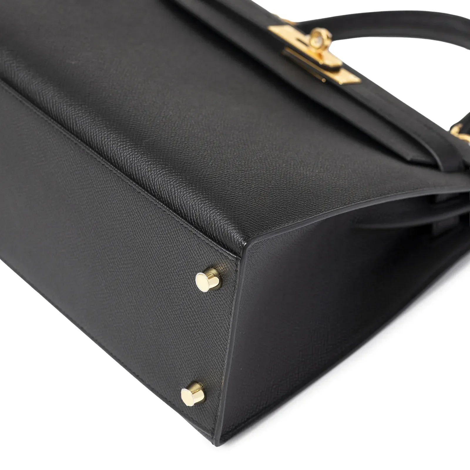 Close-up bottom view of Hermès Kelly 28 Sellier Black Epsom Gold Hardware showing leather texture and metal feet