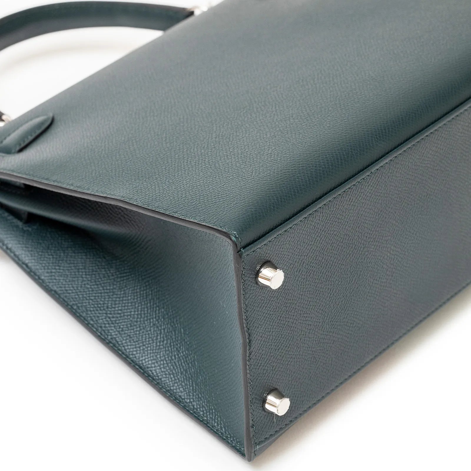 Close-up of bottom corner and palladium feet on Hermès Kelly 28 Sellier Lettre H Vert Cypress/Bleu Obscur/Malachite Veau Epsom Palladium Hardware