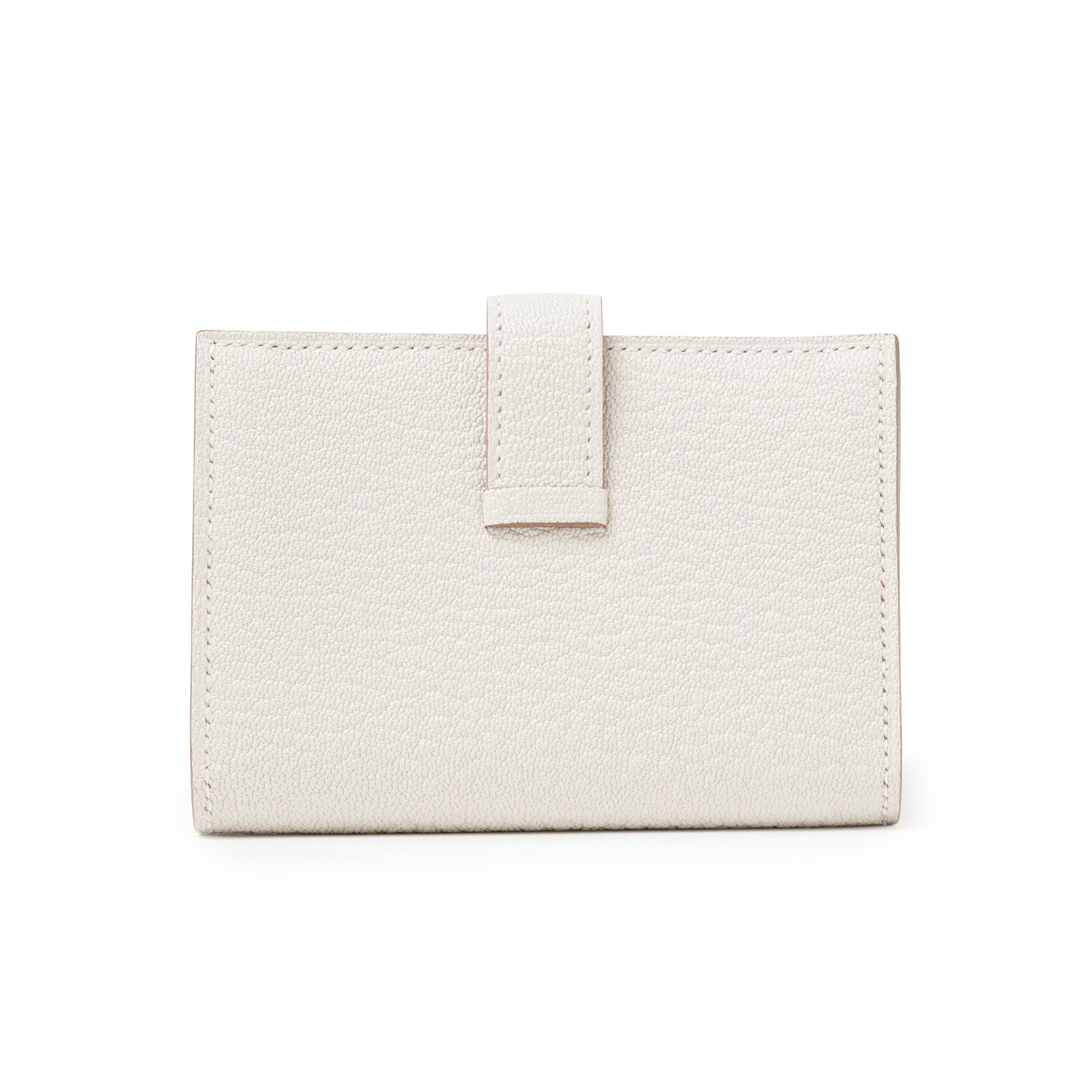 Back view of Hermès Mini Bearn Wallet Beton Chevre Mysore Gold Hardware showing textured leather and closure strap