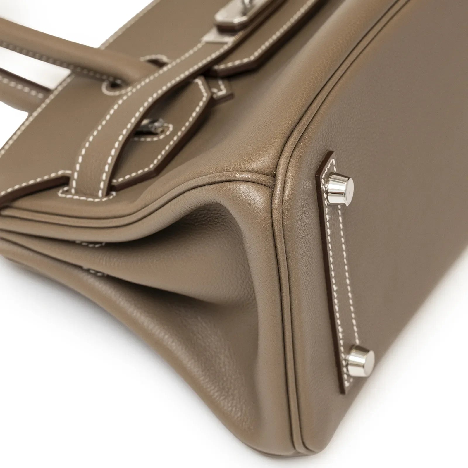 Close-up angled view of Hermès Birkin 29 Etoupe Evercolor leather corner and palladium hardware feet detail.