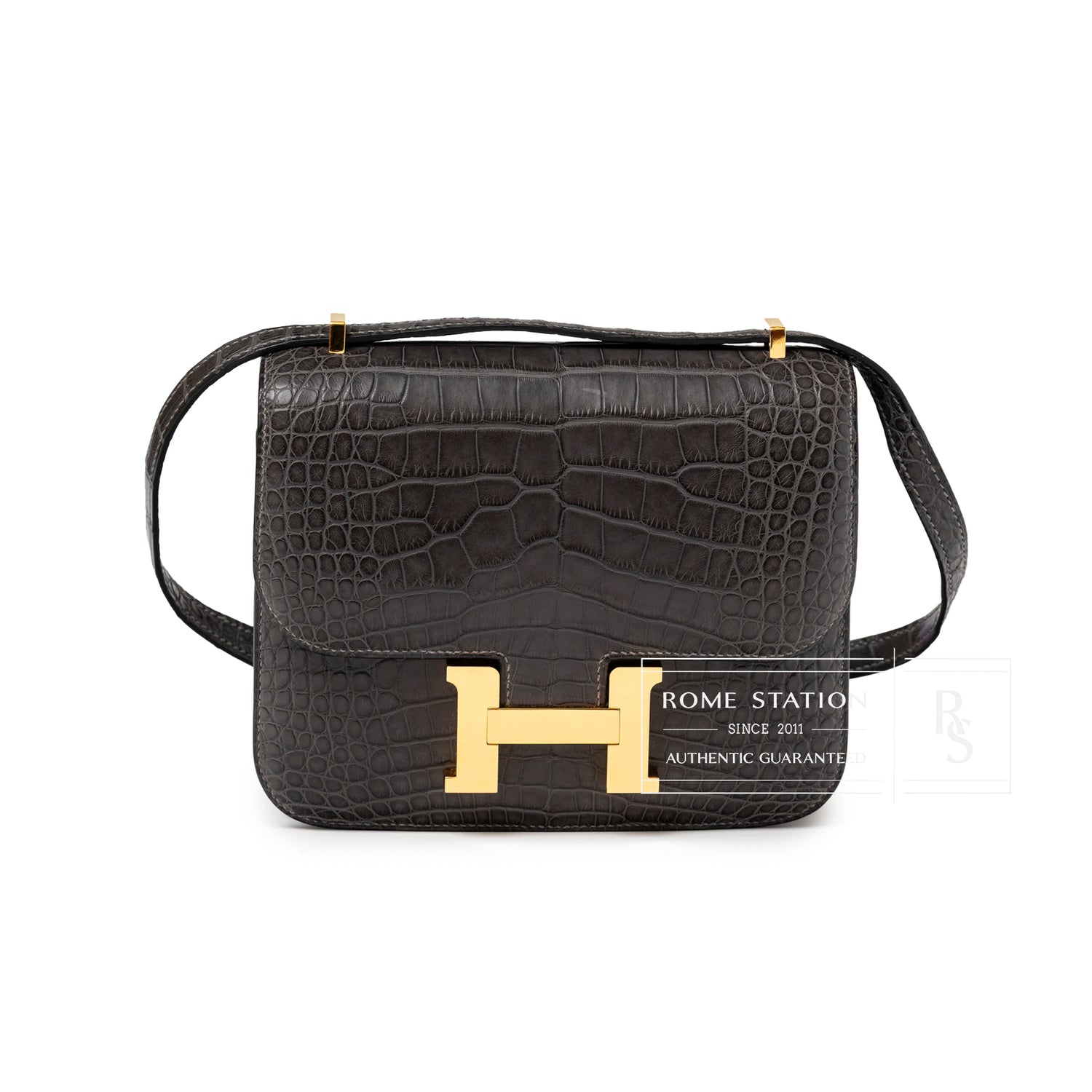 Front view of Hermès Mini Constance 18 Graphite Matte Alligator Gold Hardware with signature H clasp and textured leather