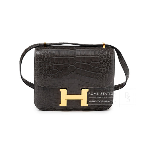 Front view of Hermès Mini Constance 18 Graphite Matte Alligator Gold Hardware with signature H clasp and textured leather