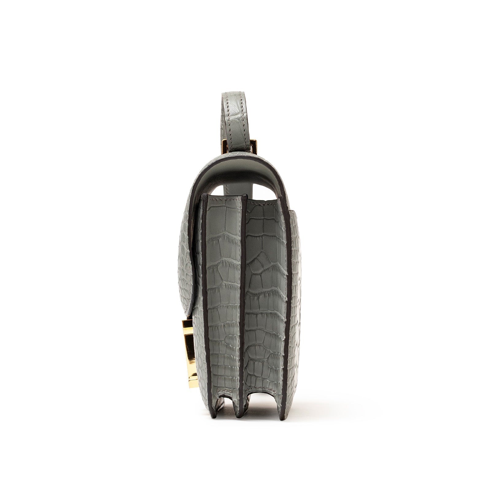 Side view of Hermès Mini Constance 18 Gris Ciment Matte Alligator Gold Hardware showing texture and compartments
