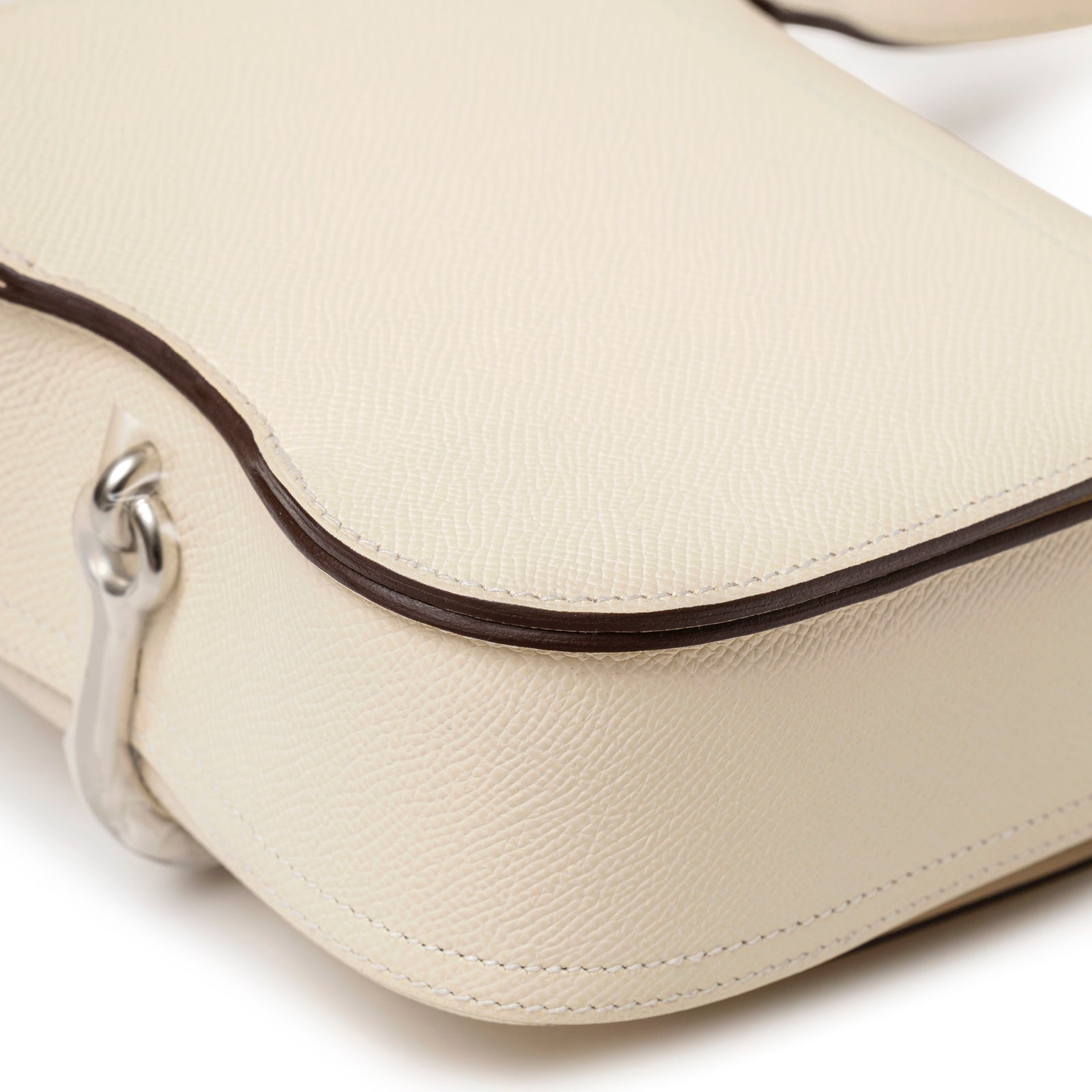 Close-up angled view of Hermès Mini Della Cavalleria Craie Epsom Palladium Hardware showing smooth cream leather texture and stitching detail