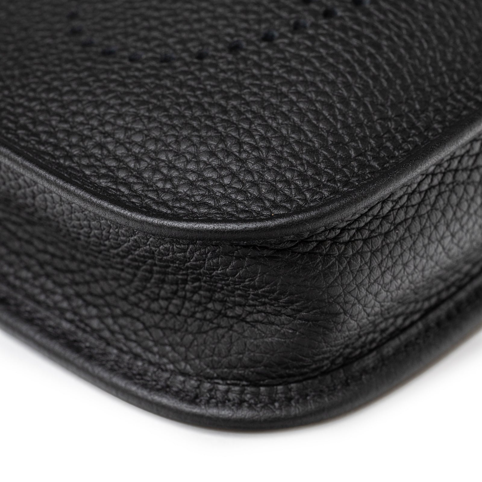Close-up of Hermès Mini Evelyne Black Clemence Palladium Hardware corner showing fine leather grain and stitch craftsmanship