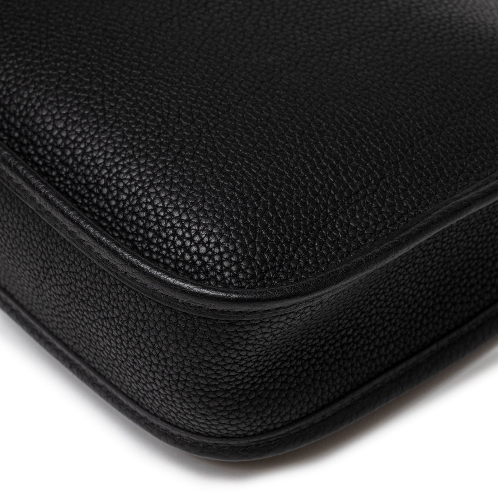 Close-up of corner detailing on Hermès Mini Evelyne Caban Blue Zellige Indigo Clemence Palladium Hardware showing textured leather grain