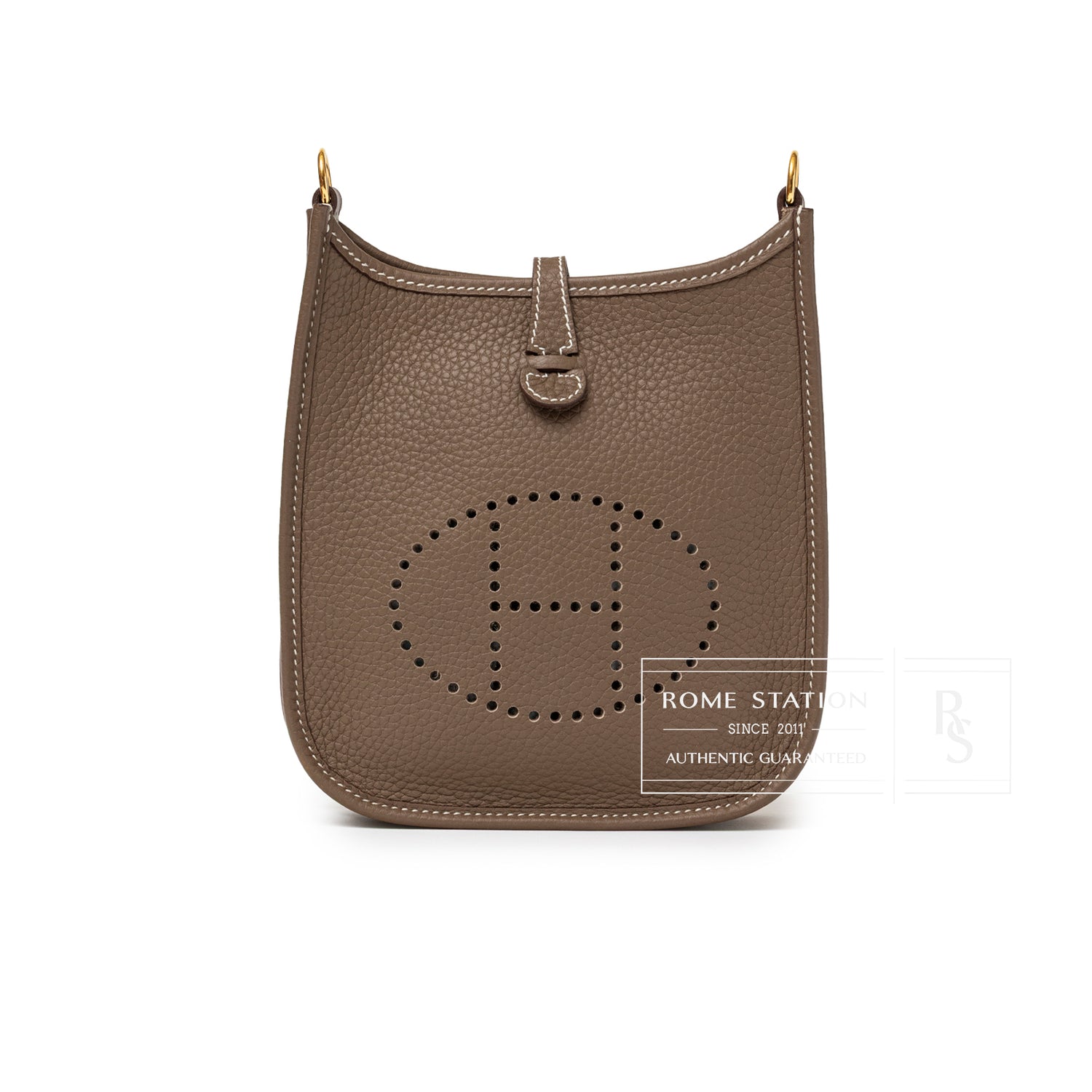 Front view of Hermès Mini Evelyne Etoupe Blue Indigo Clemence Gold Hardware with perforated H logo and textured leather