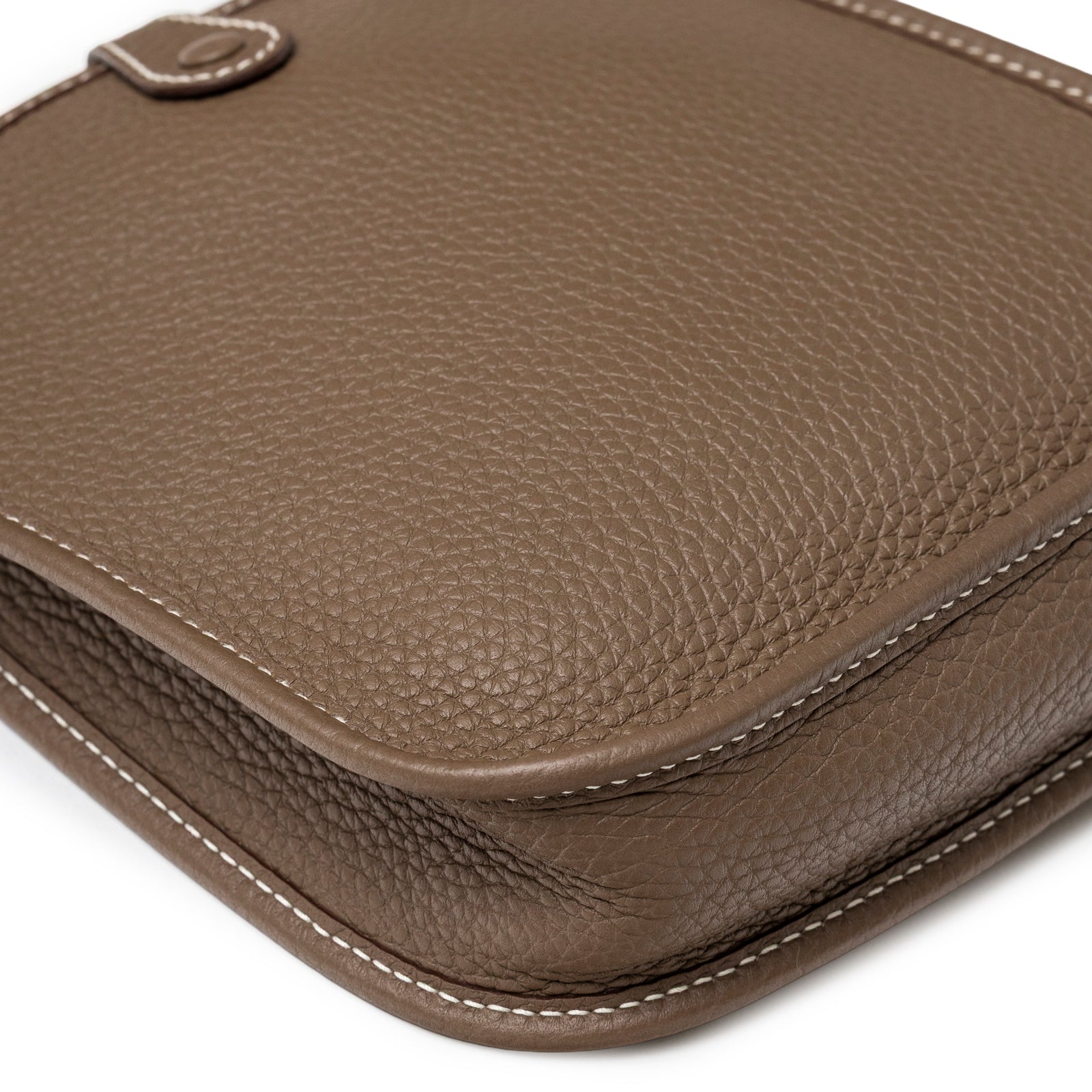Close-up of corner and textured Clemence leather on Hermès Mini Evelyne Etoupe Blue Indigo Clemence Gold Hardware showing fine stitching detail