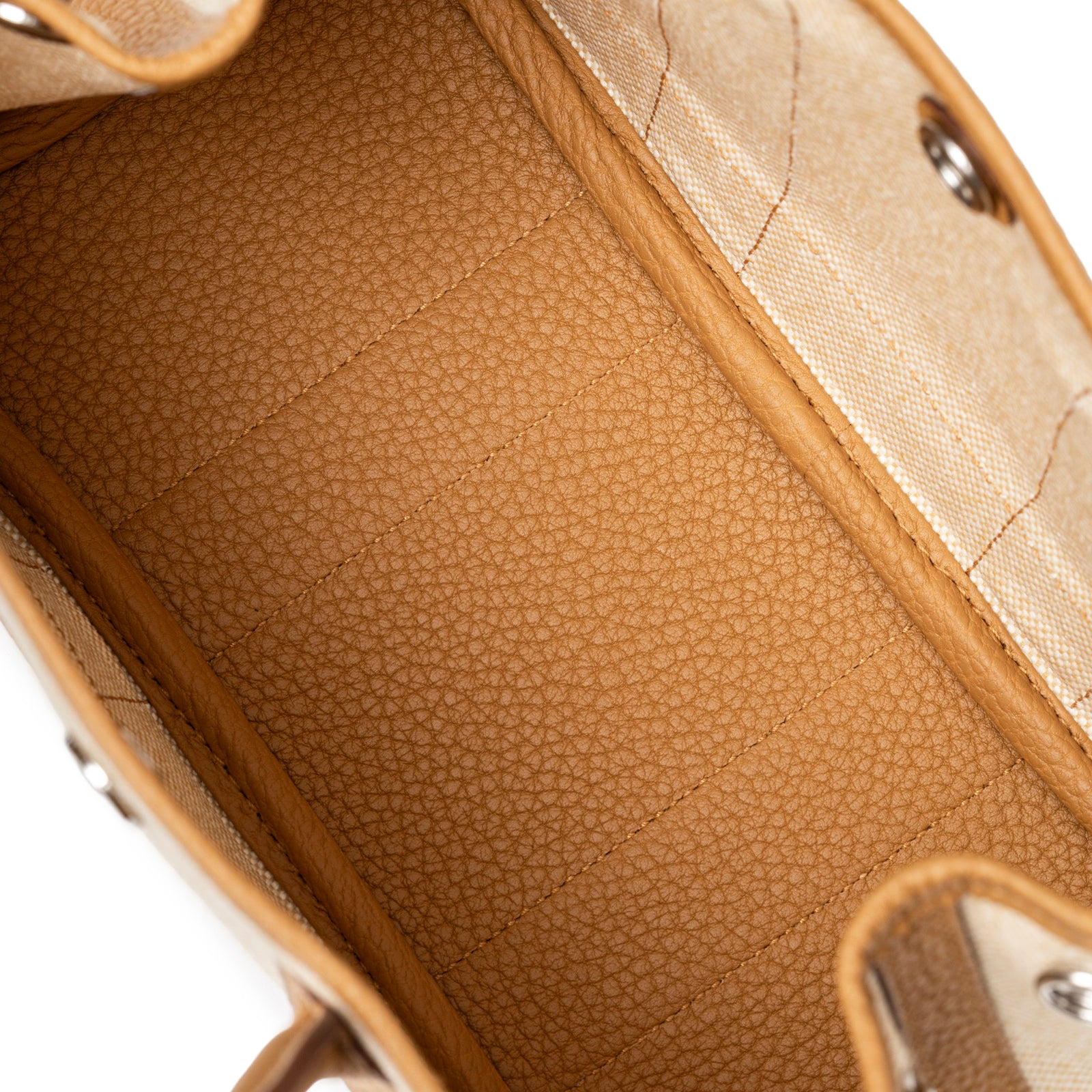 Interior view showing textured Sesame Negonda leather lining and canvas on Hermès Mini Garden Party Neo 23 Ecru-Paille Toile H Canvas and Sesame Negonda Palladium Hardware