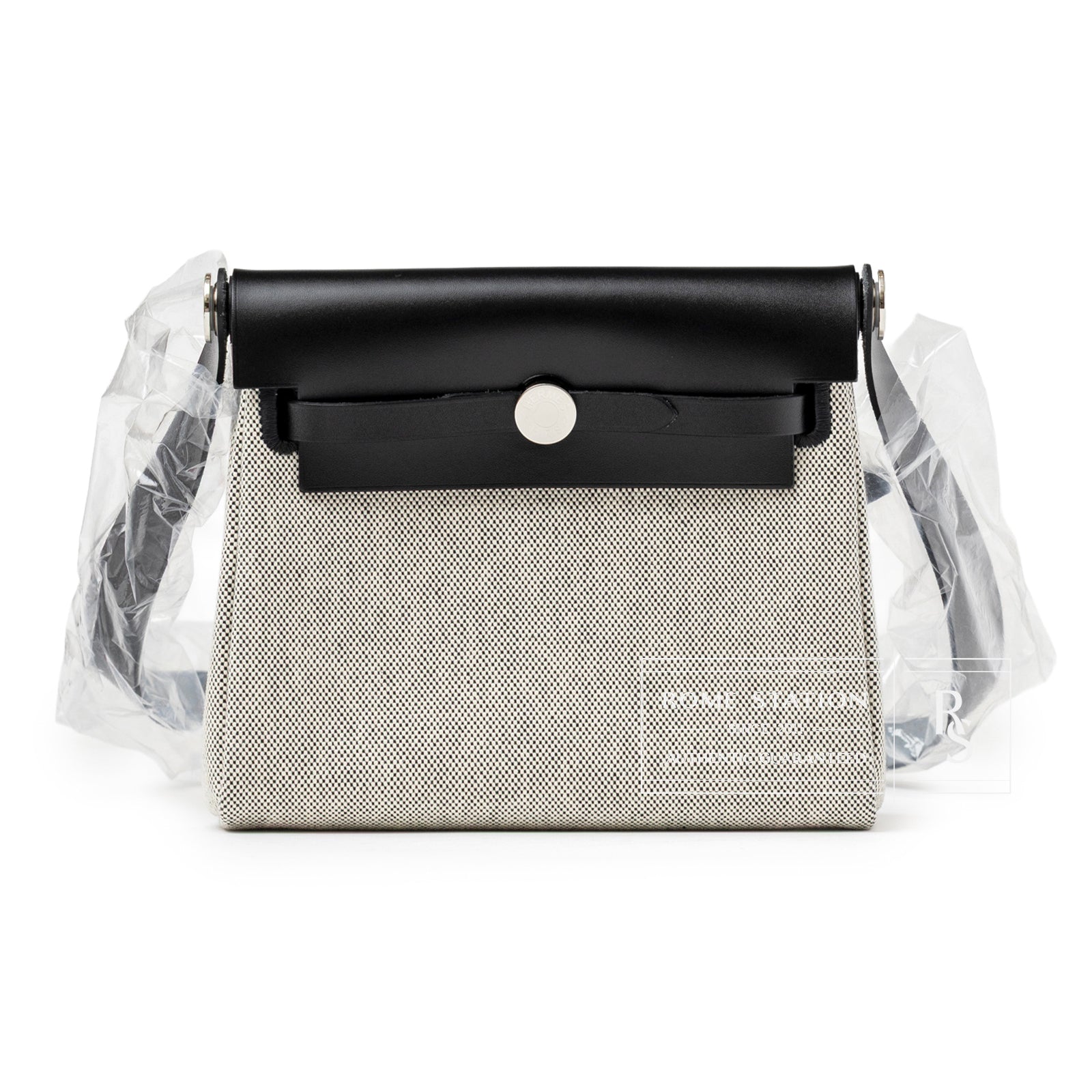 Front view of Hermès Mini Herbag Zip 20 Ecru/Black Toile and Vache Hunter Palladium Hardware with strap wrapped