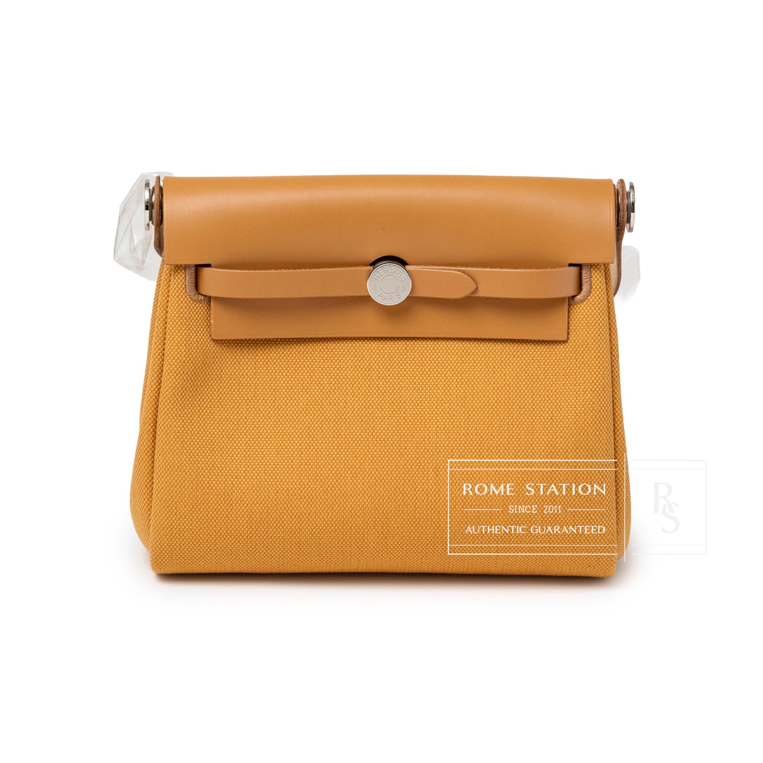 Front view of Hermès Mini Herbag Zip 20 Naturel Sable Toile and Vache Hunter Palladium Hardware showing clasp and structured silhouette