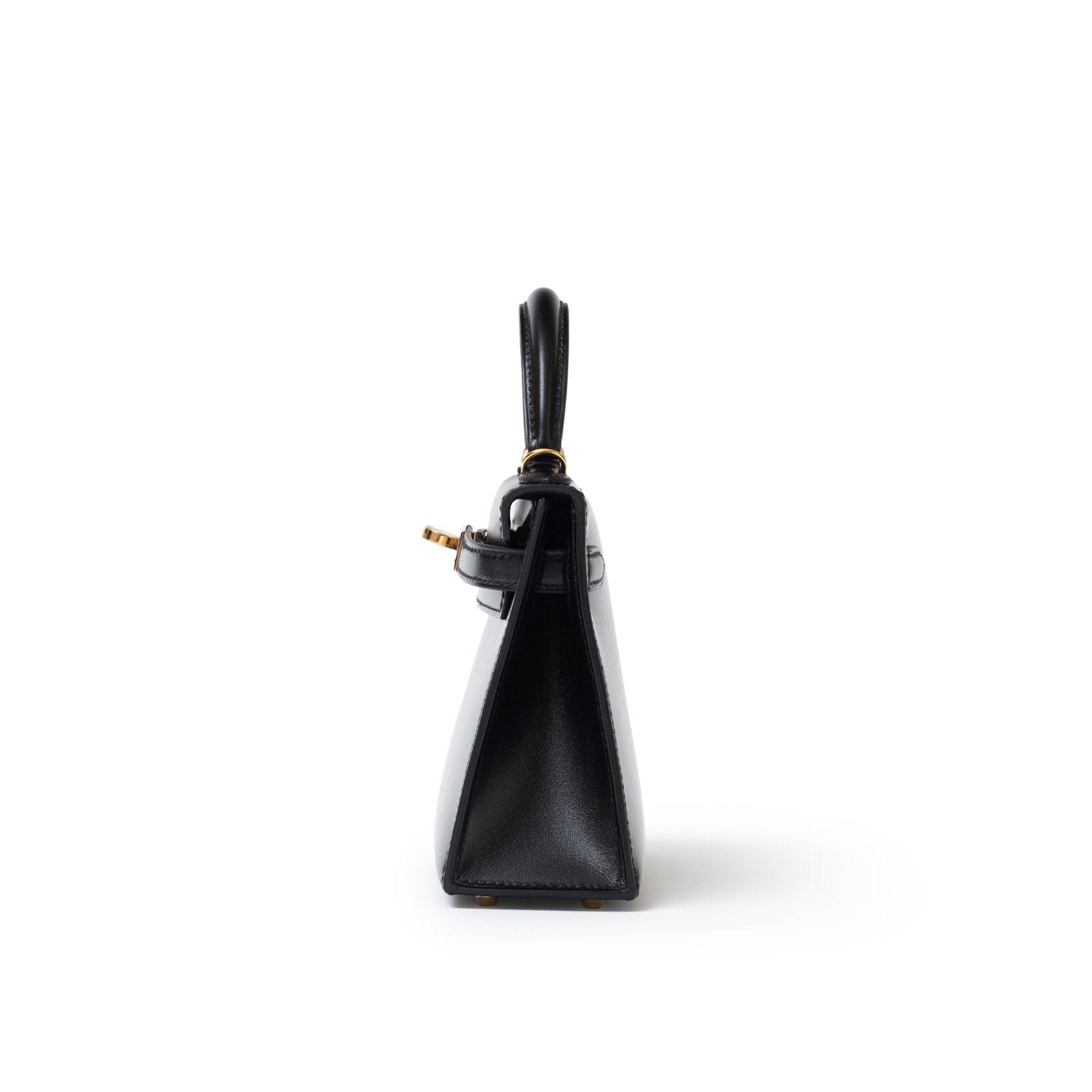 Side profile of Hermès Mini Kelly II Sellier 20 Black Box Gold Hardware showing slim silhouette and handle detail