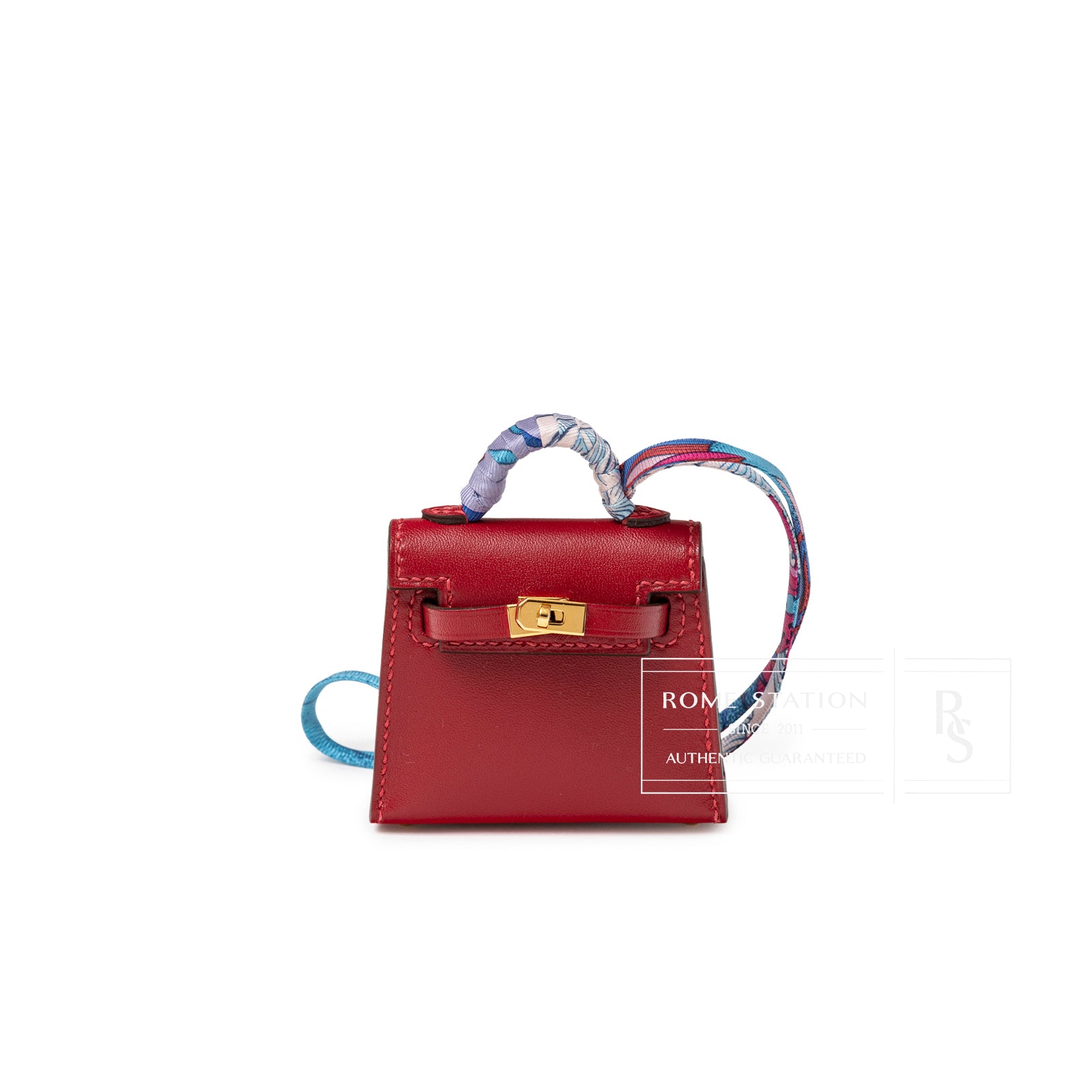 Front view of Hermès Mini Kelly Twilly Bag Charm Rouge Tadelakt Gold Hardware with colorful wrapped handle