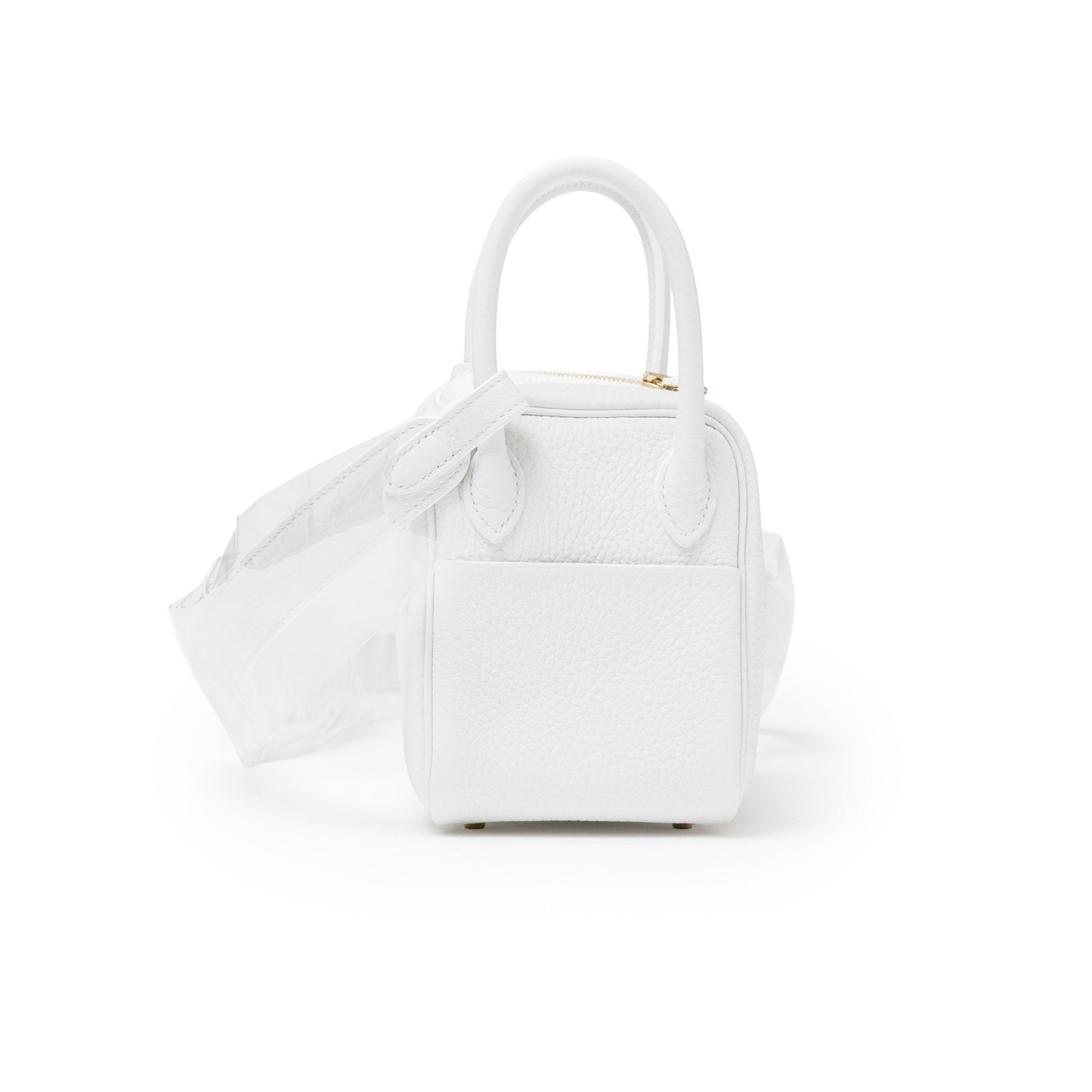 Rear angled view of Hermès Mini Lindy II New White Clemence Gold Hardware showing textured leather and handles
