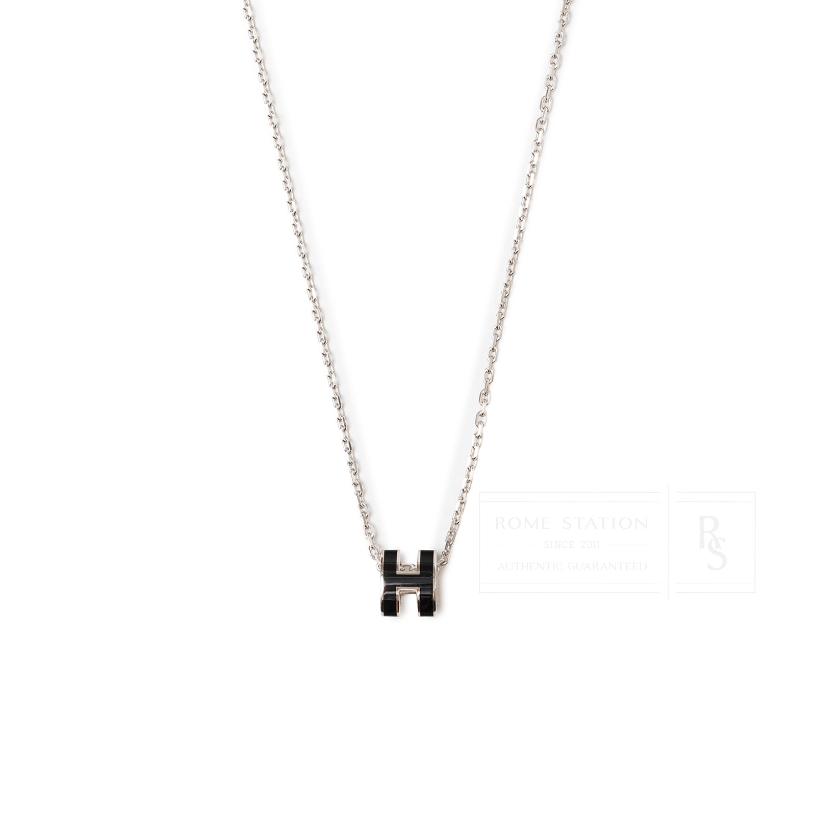 Close-up front view of Hermès Mini Pop H Pendant Black Palladium Plated on delicate chain necklace.