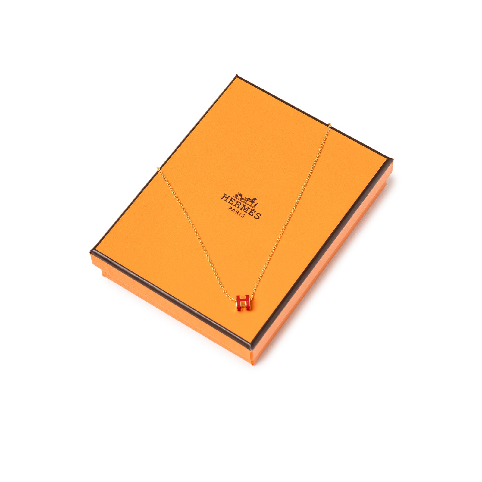 Hermès Mini Pop H Pendant Red Gold Plated necklace with red H charm on chain displayed on orange box