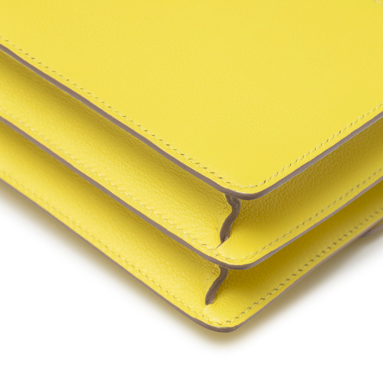 Close-up of corner and stitching detail on Hermès Mini Roulis Lime Evercolor Permabrass Hardware handbag