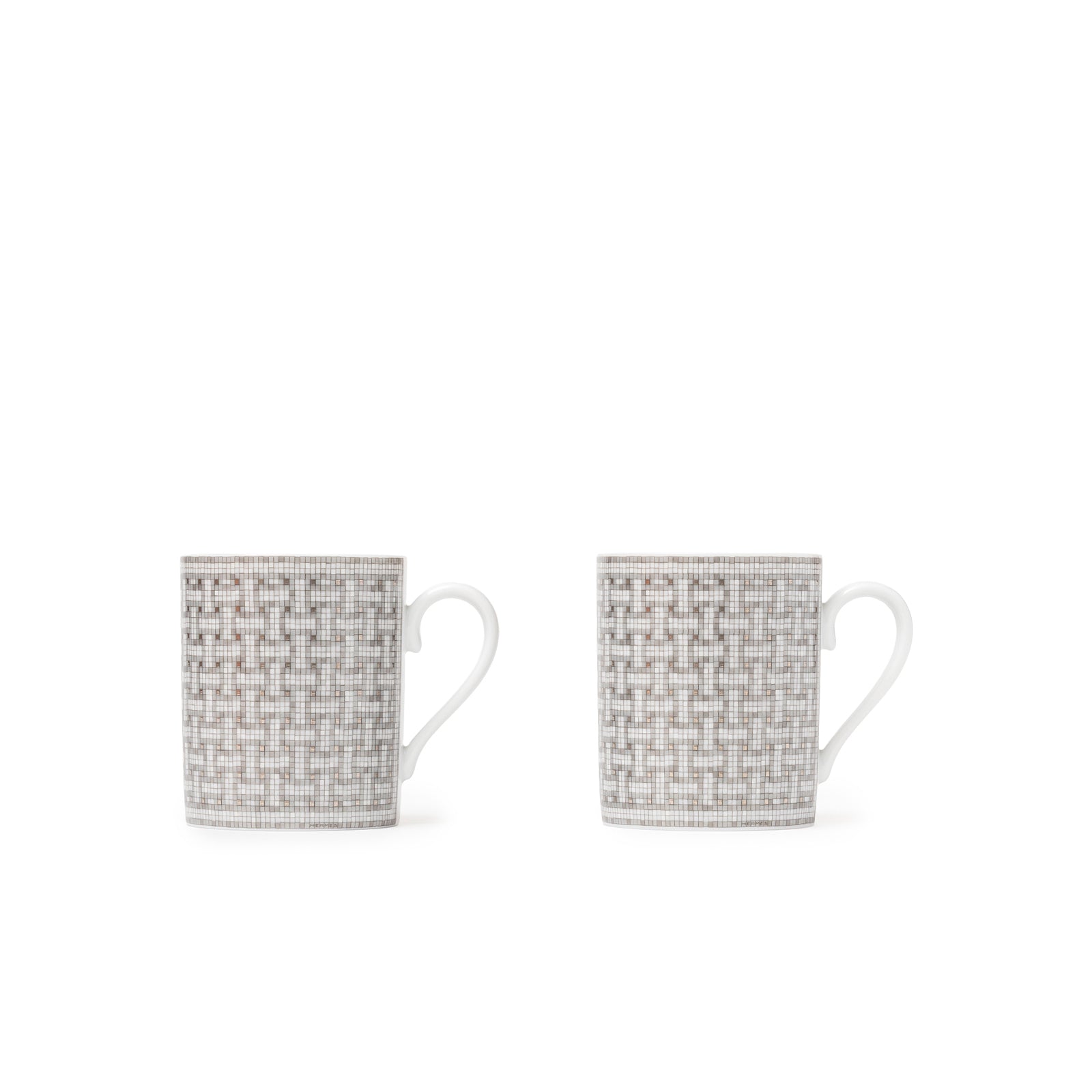 Pair of Hermès Mosaique au 24 Platinum Mugs showing geometric platinum mosaic design on white porcelain, front view.