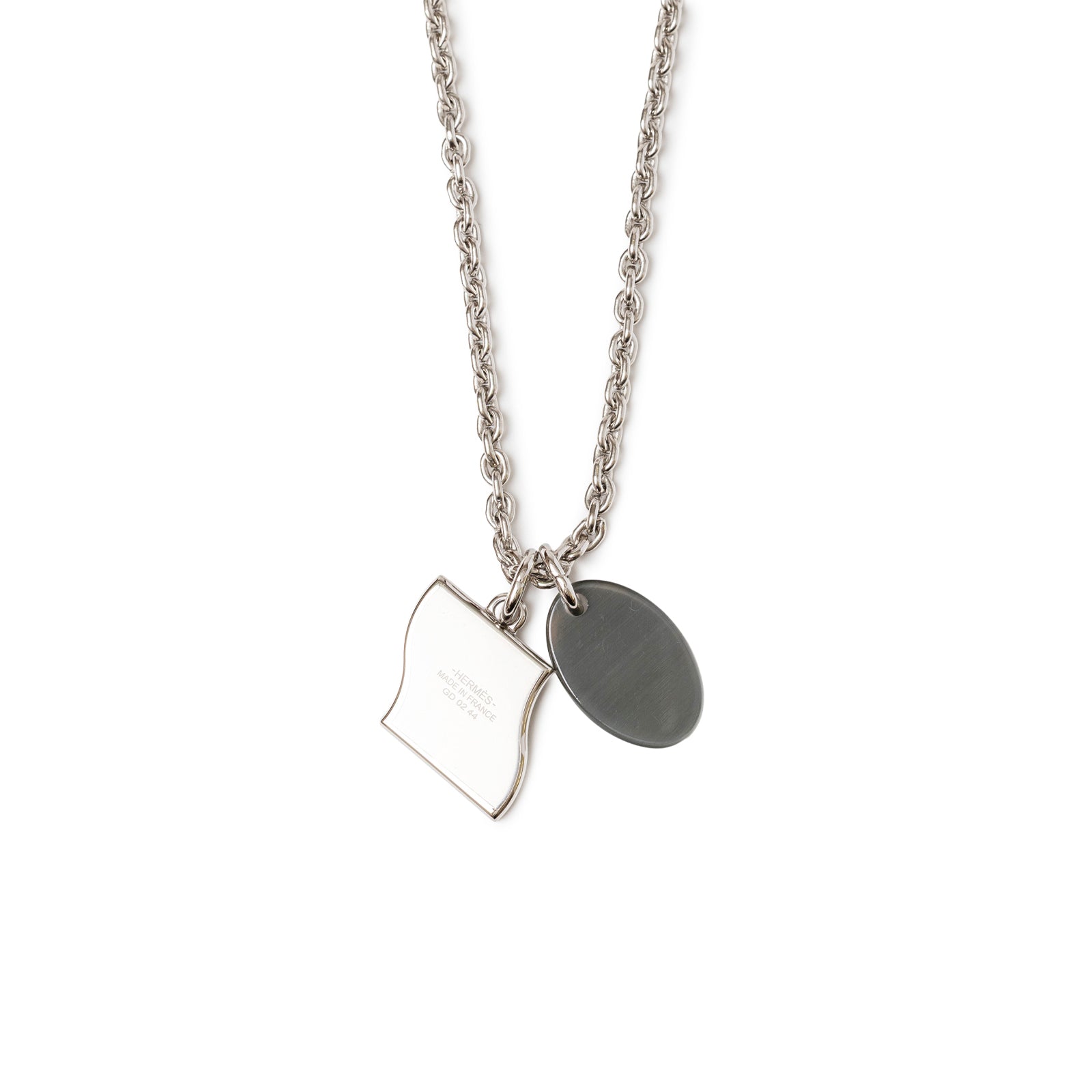 Close-up front back view of Hermès Parade Necklace Orange Pulpe Transparent with silver chain and two polished pendants