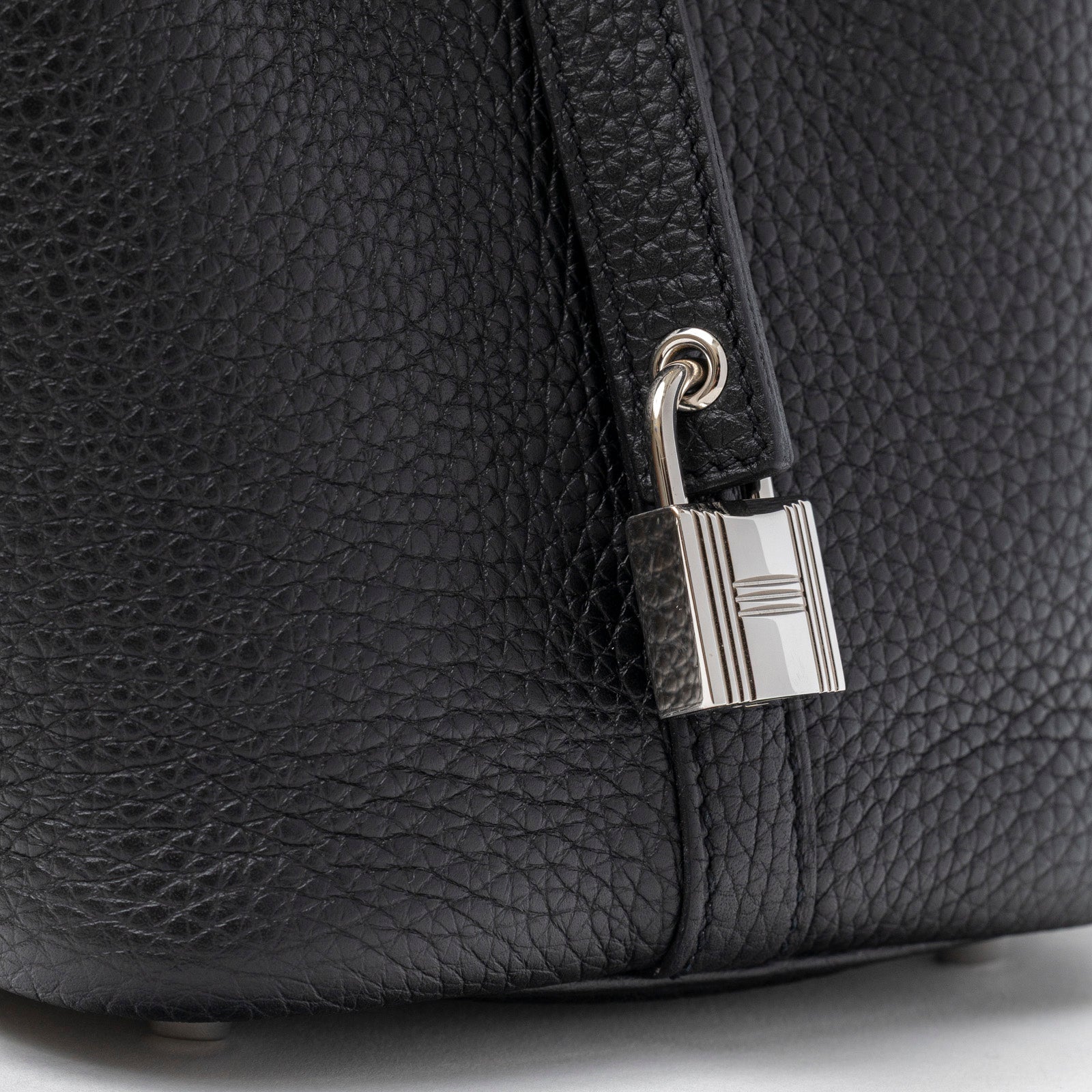 Close-up of palladium hardware lock detail on Hermès Picotin 18 Black Clemence Palladium Hardware bag side angle